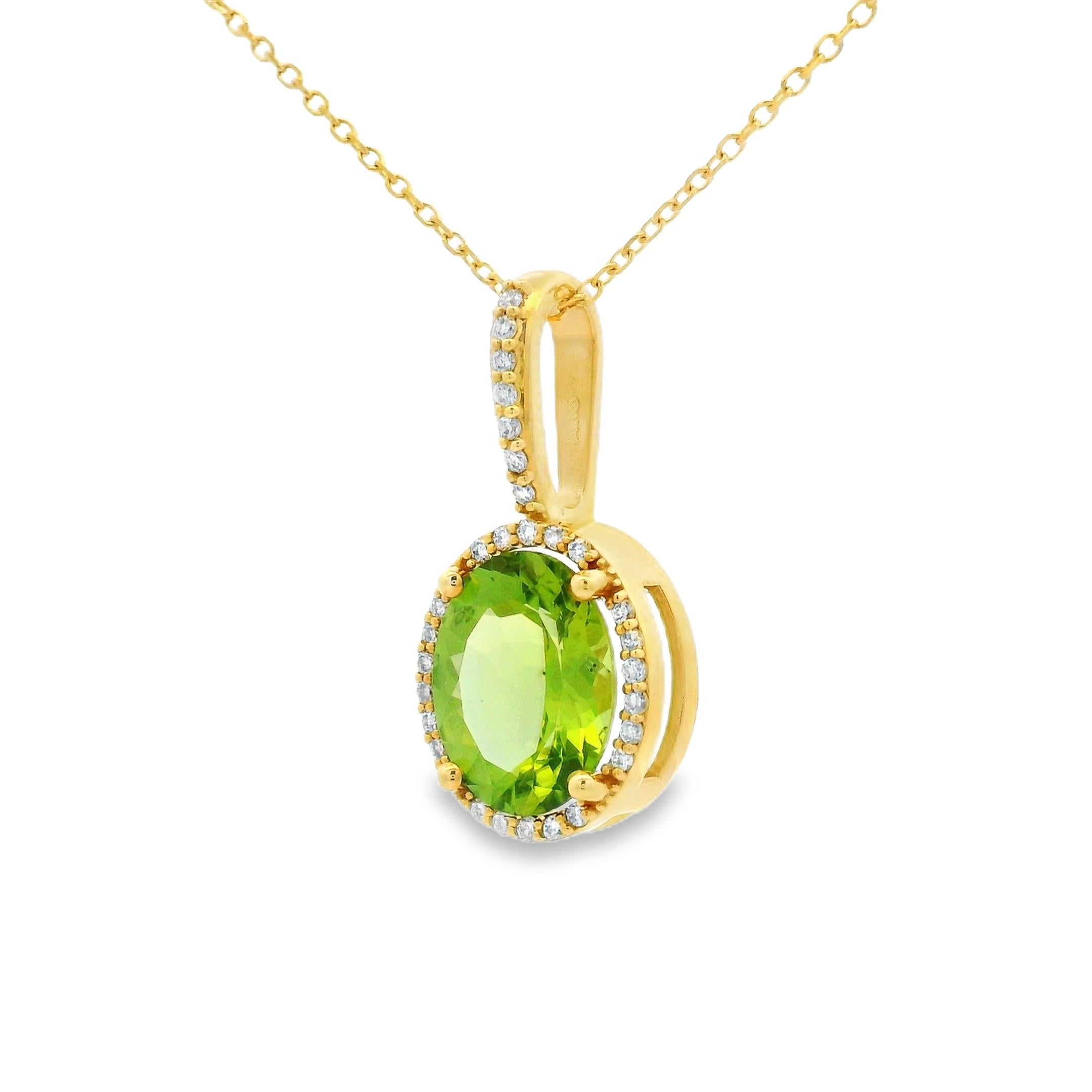This elegant pendant showcases a vivid 2.40-carat oval peridot framed in a delicate halo of diamonds, all set in 14K yellow gold. The centerpiece gem measures 10x8mm, offering a lively burst of green color with excellent clarity and brilliance.