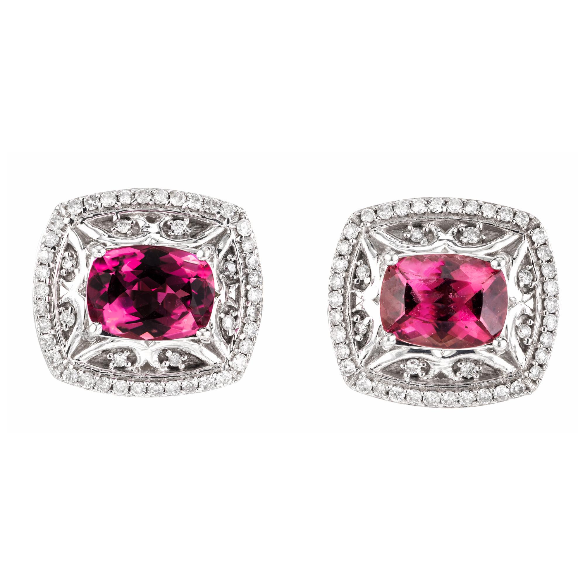 Elegant tourmaline and diamond earrings. These stunning earrings begin with 2 oval pink tourmalines totaling 2.40cts. Set in 14k white gold filigree settings with round full cut diamond halos. The captivating pink tourmaline gemstones exude a