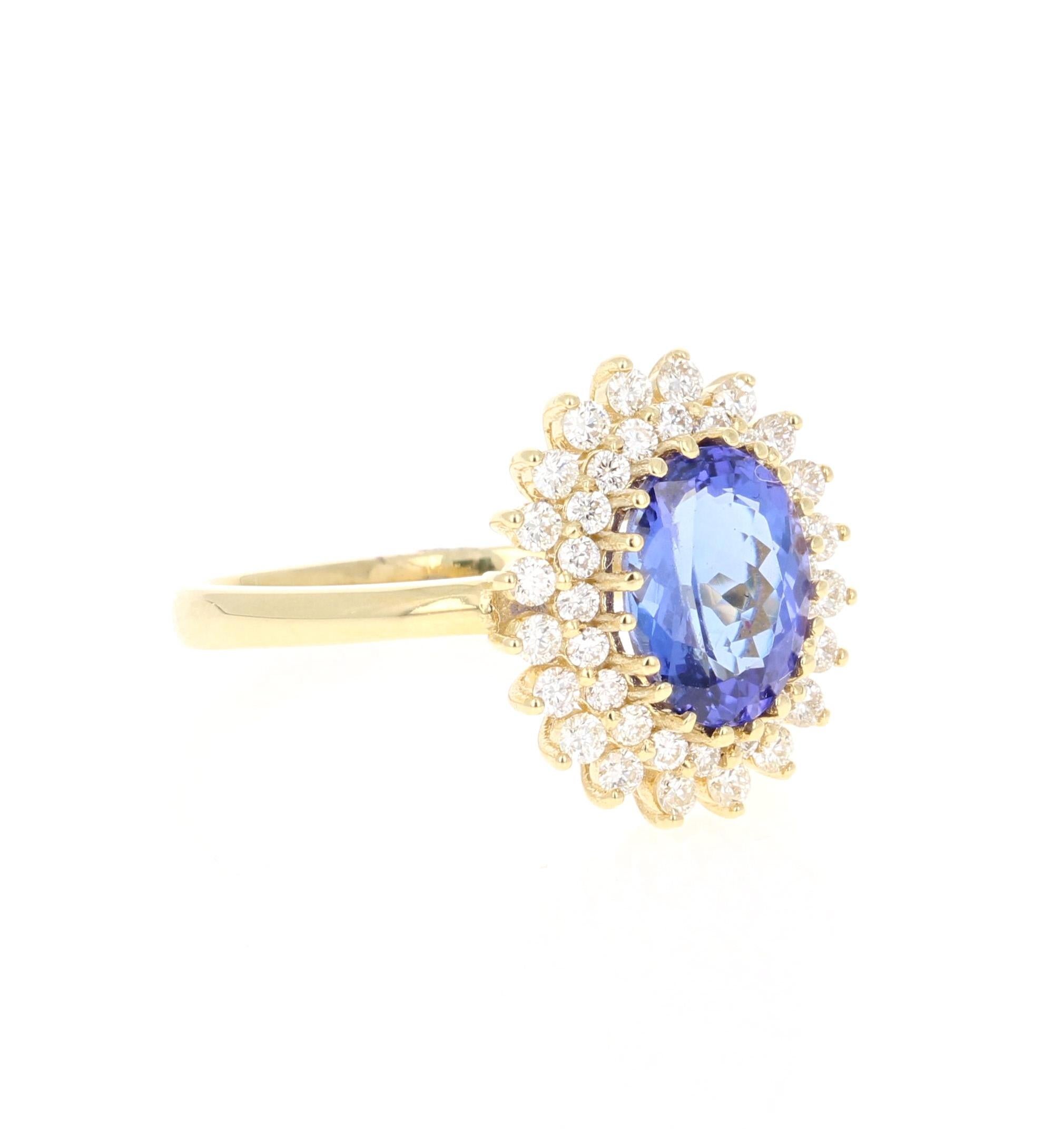 This beautiful ring has a vivid 1.87 Carat Oval Cut Tanzanite. The Tanzanite is surrounded by 40 Round Cut Diamonds that weigh 0.53 carats. (Clarity: VS, Color: H) The total carat weight of the ring is 2.40 carats. 

The ring is made in 18K Yellow