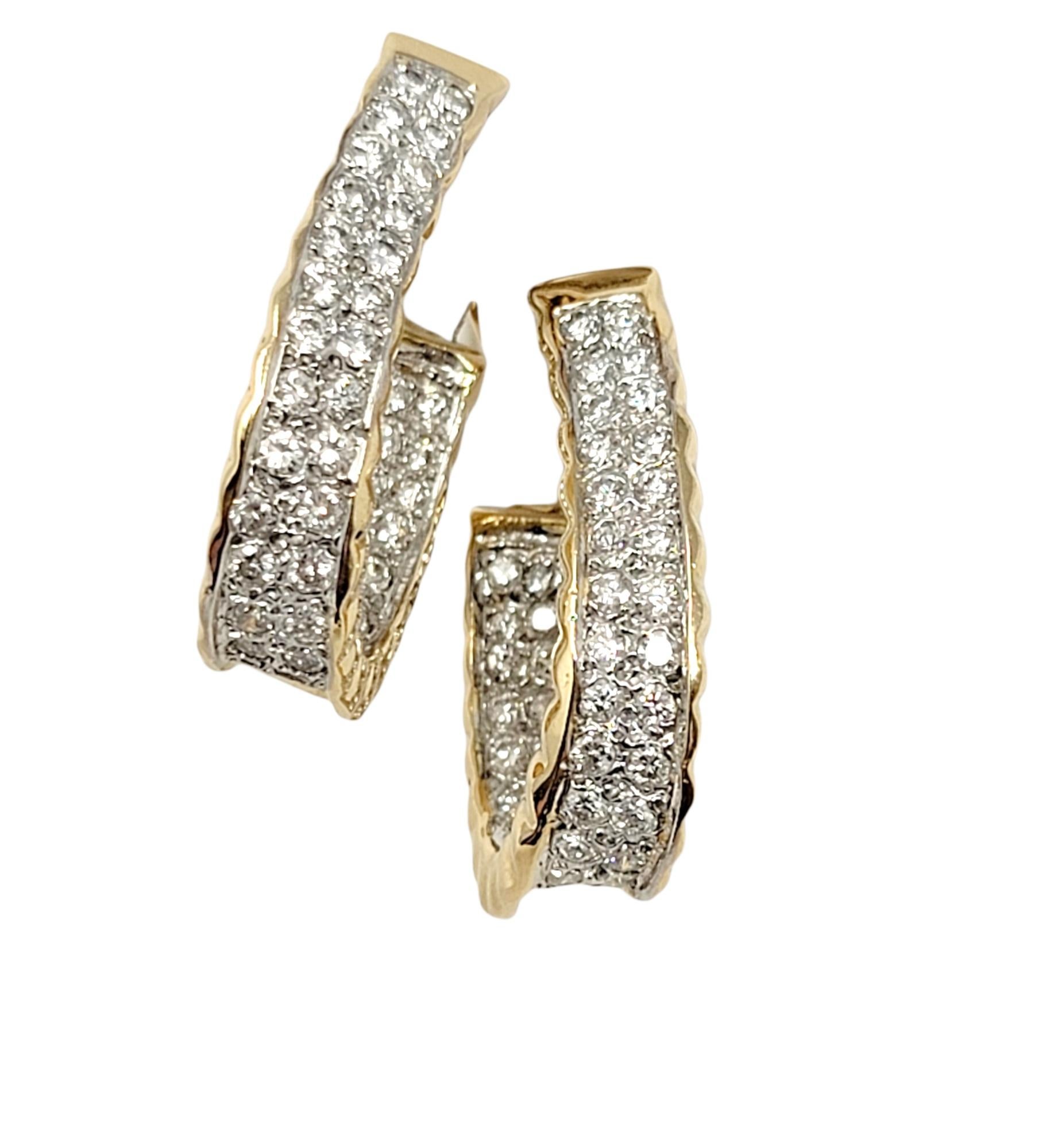 These beautiful diamond encrusted half hoop earrings shimmer and shine on the ear and offer incredible sparkle! The icy white stones really pop against the textured yellow gold setting, while the unique inside/outside setting allows the light to hit