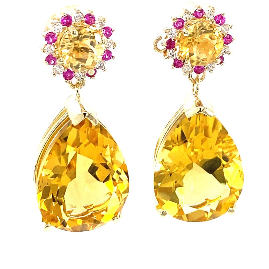 24.09 Carat Pear Cut Citrine Pink Sapphire Diamond Yellow Gold Drop Earrings

These lovely earrings have 2 vibrant Pear Cut Citrine Quartz that weigh 22.02 carats.  There are also 2 Round Cut Citrines on the top of the earrings that weigh 1.54