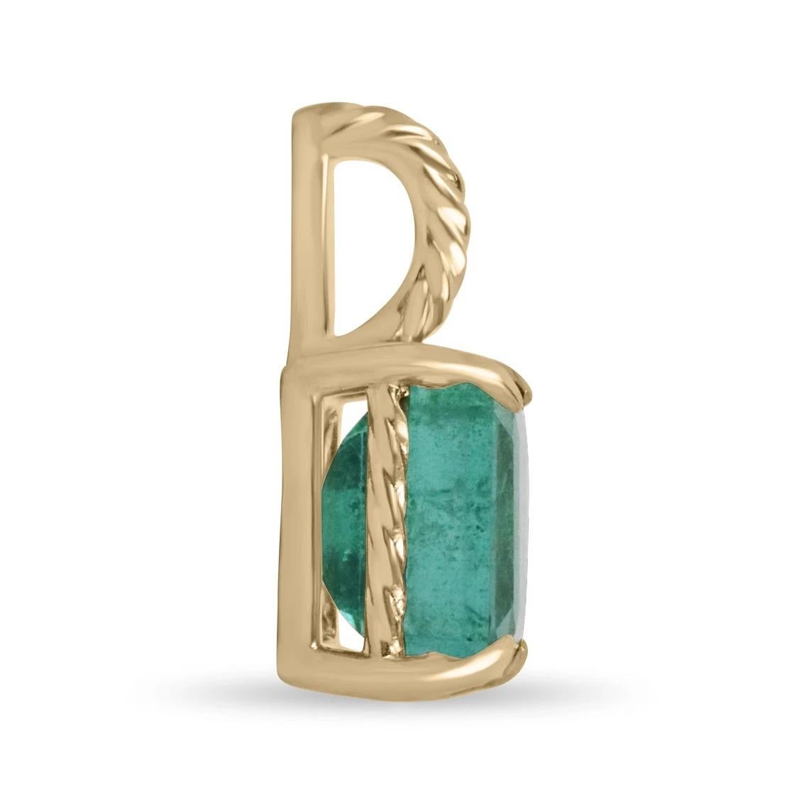 Featured here is a stunning emerald cut Zambian emerald pendant in fine 14K yellow gold. Displayed in the center is a lush bluish-green emerald with very good clarity, accented by a simple four-prong gold mount, allowing for the emerald to be shown