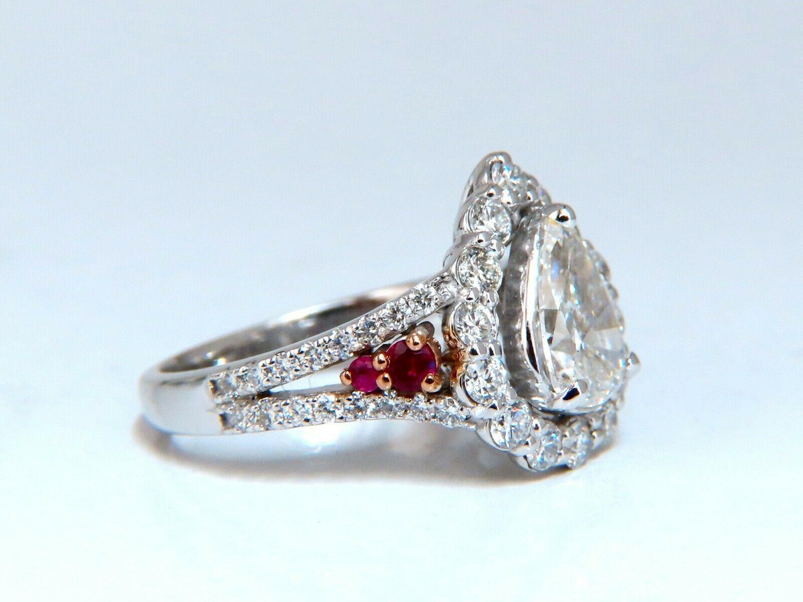 Pear Diamond cluster ring.

1.30ct. Natural Pear Shape diamond

J color Si-2 clarity 

1.00ct side round diamonds.

G-color vS-2 clarity

.10ct Natural Round Rubies

14kt. white gold.

Ring size: 7

We may resize.

Deck of ring: 15 X 12mm

Depth of