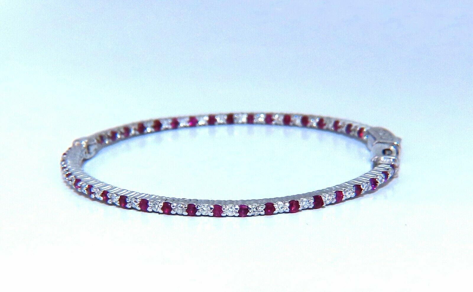 Inside/out  natural Ruby and Diamond hoop earrings.

1.64ct. round rubies, full brilliant cut clean clarity and transparent

.76ct. natural round diamonds G color vs2 clarity.

14 karat white gold 12.2 grams

50mm wide (front to back)

1.6 mm wide