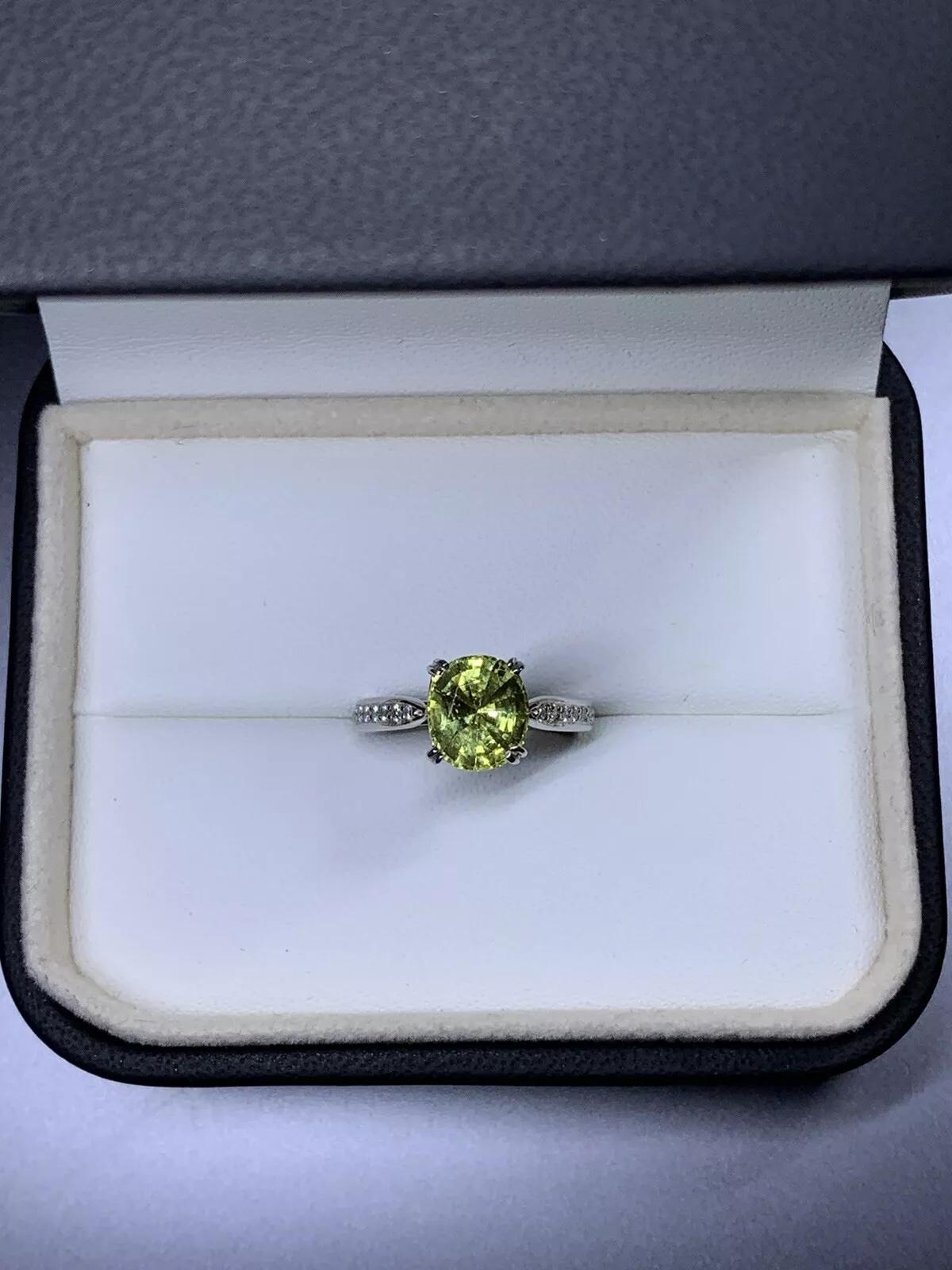 2.40ct Peridot and diamond engagement ring in platinum.

Beautiful green vivid peridot oval cut gemstone untreated total weight 2.00ct

Diamonds total weight 0.40ct F colour VS1 clarity

Hallmarked

The ring can be resized

Box. Insurance and