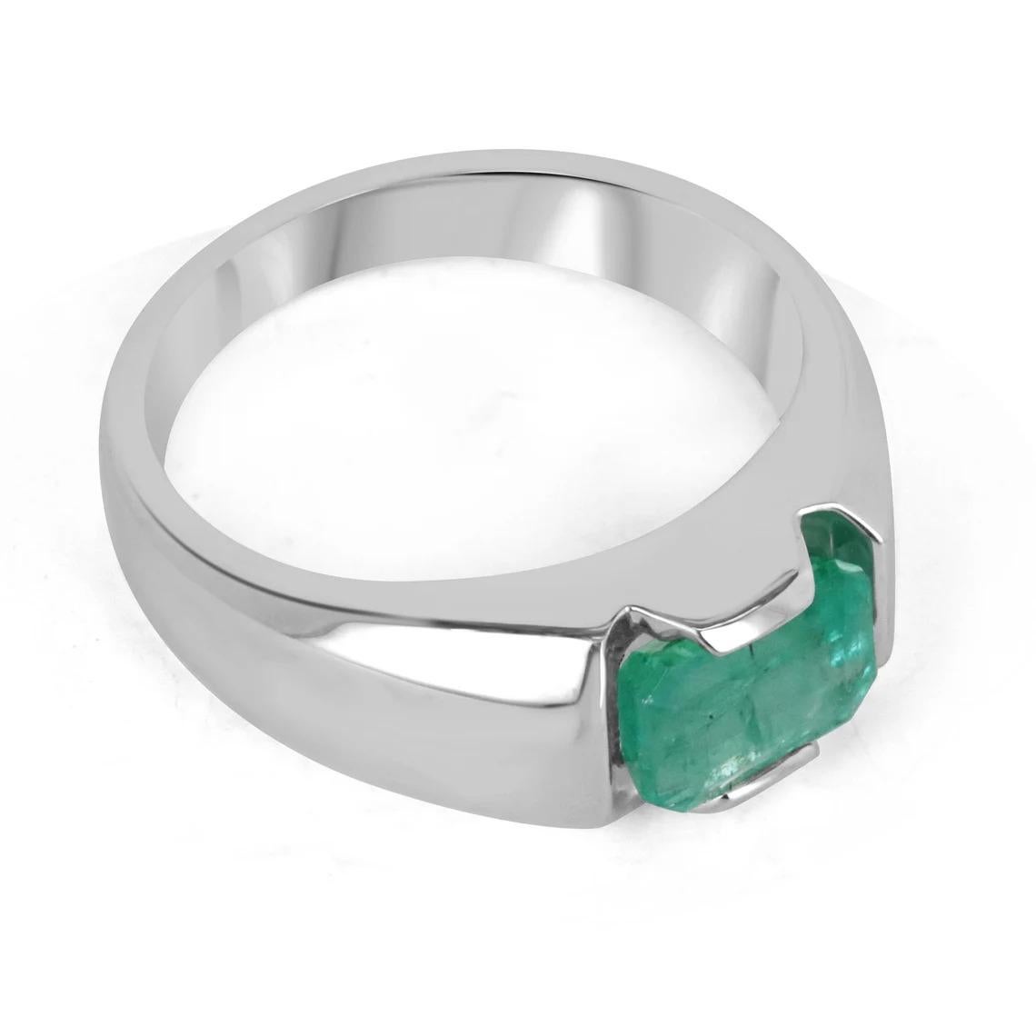 A dapper natural emerald-emerald cut solitaire ring. This exquisite piece features a perfectly imperfect emerald cut emerald from the mines of Zambia. The gemstone showcases a beautiful shine, mossy medium green color, and very good luster. Natural
