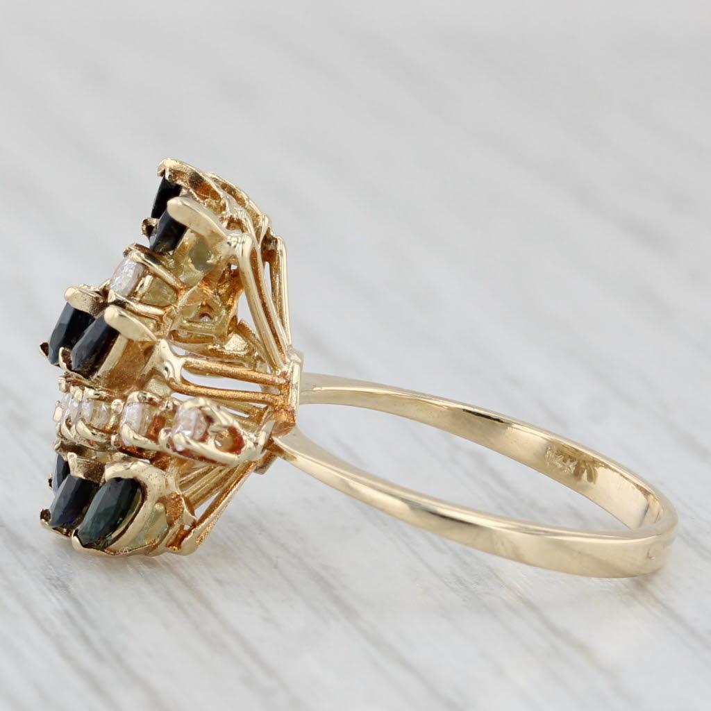 Gemstone Information:
- Natural Sapphires -
Total Carats - 2ctw
Cut - Marquise Brilliant
Color - Dark Blue
Treatment - Heated

- Natural Diamonds -
Total Carats - 0.40ctw
Cut - Round Brilliant
Color - G - H
Clarity - I1 

Metal: 14k Yellow