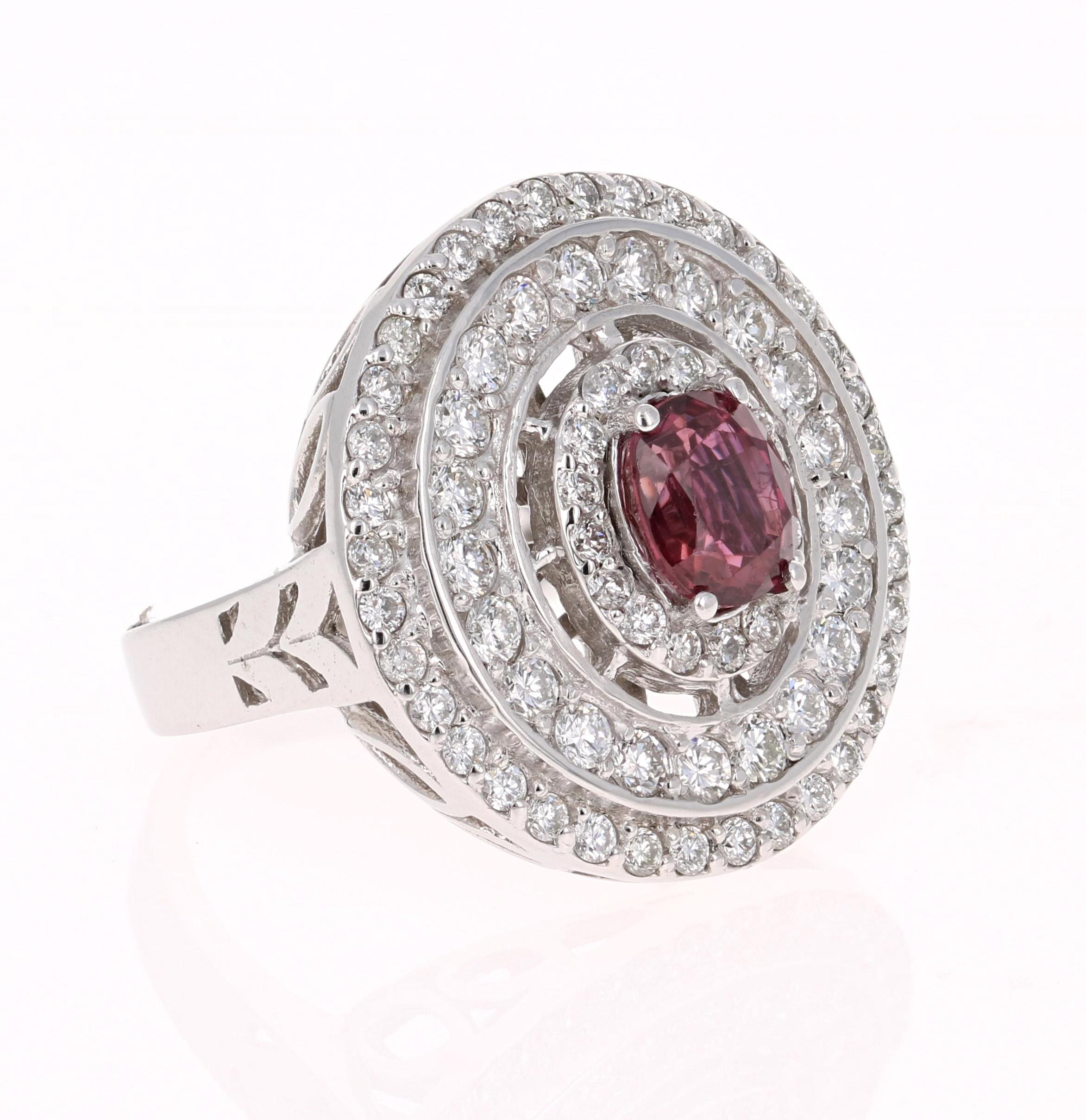 A real statement piece - Ruby and Diamond Cocktail Ring in 14K White Gold!
This ring has a gorgeous Burmese Oval Cut Ruby that weighs 1.20 carats in the center and is surrounded by 3 rows of 73 Round Cut Diamonds that weigh 1.21 carats (Clarity: