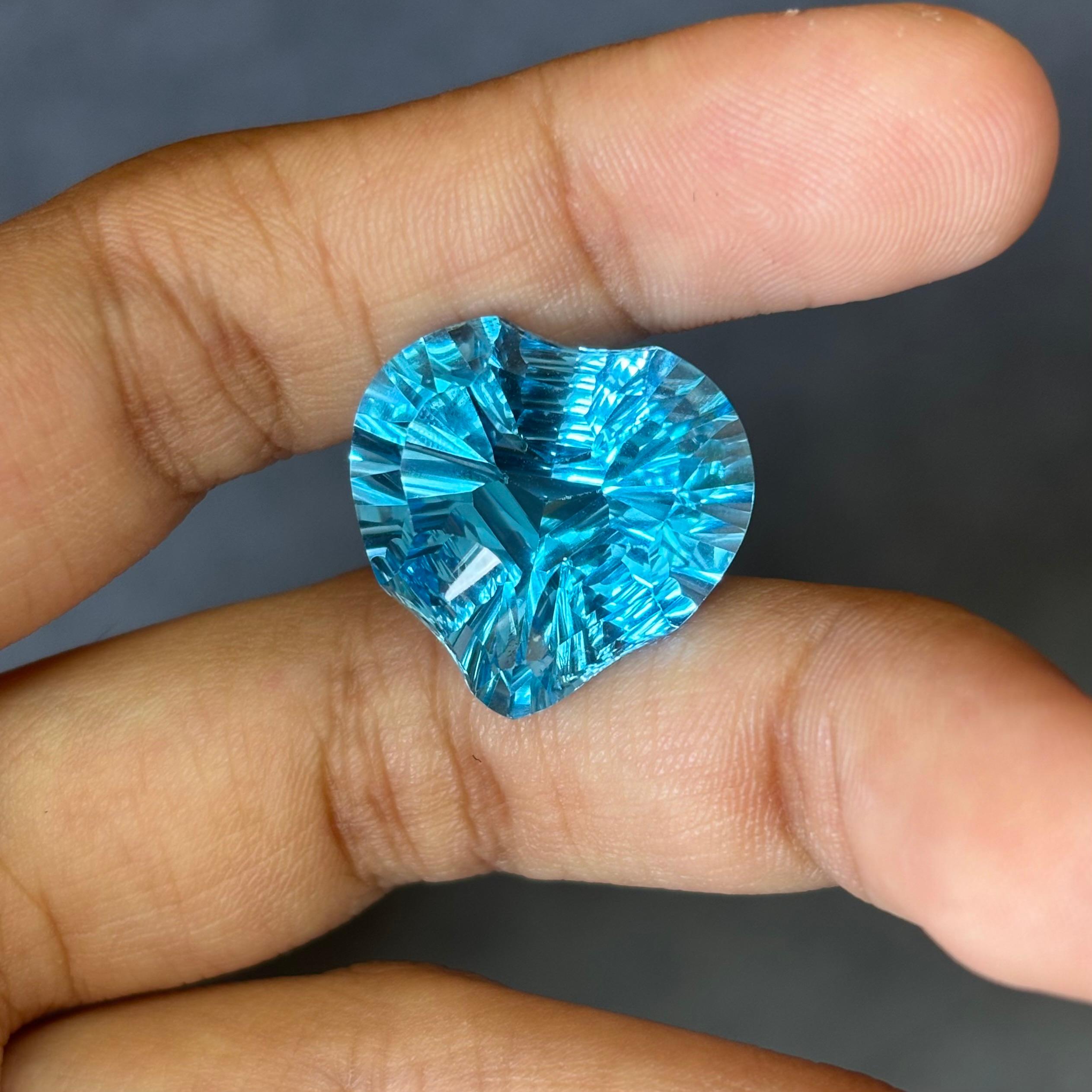 A stunning 24.12 Carat Topaz gemstone. It is completely natural and it is a clean stone.  The topaz has a unique and breath-taking  blue color that is sure to allure you at first sight! The topaz is cut to perfection in a gorgeous and unique heart