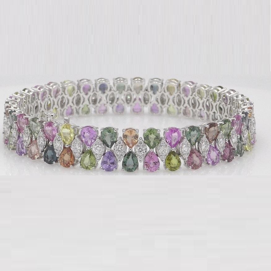 Indulge in the captivating allure of this exquisite bracelet, a true testament to elegance and sophistication. Crafted with meticulous precision, it boasts seventy-four resplendent multicolor pear-shaped sapphires, collectively weighing a remarkable