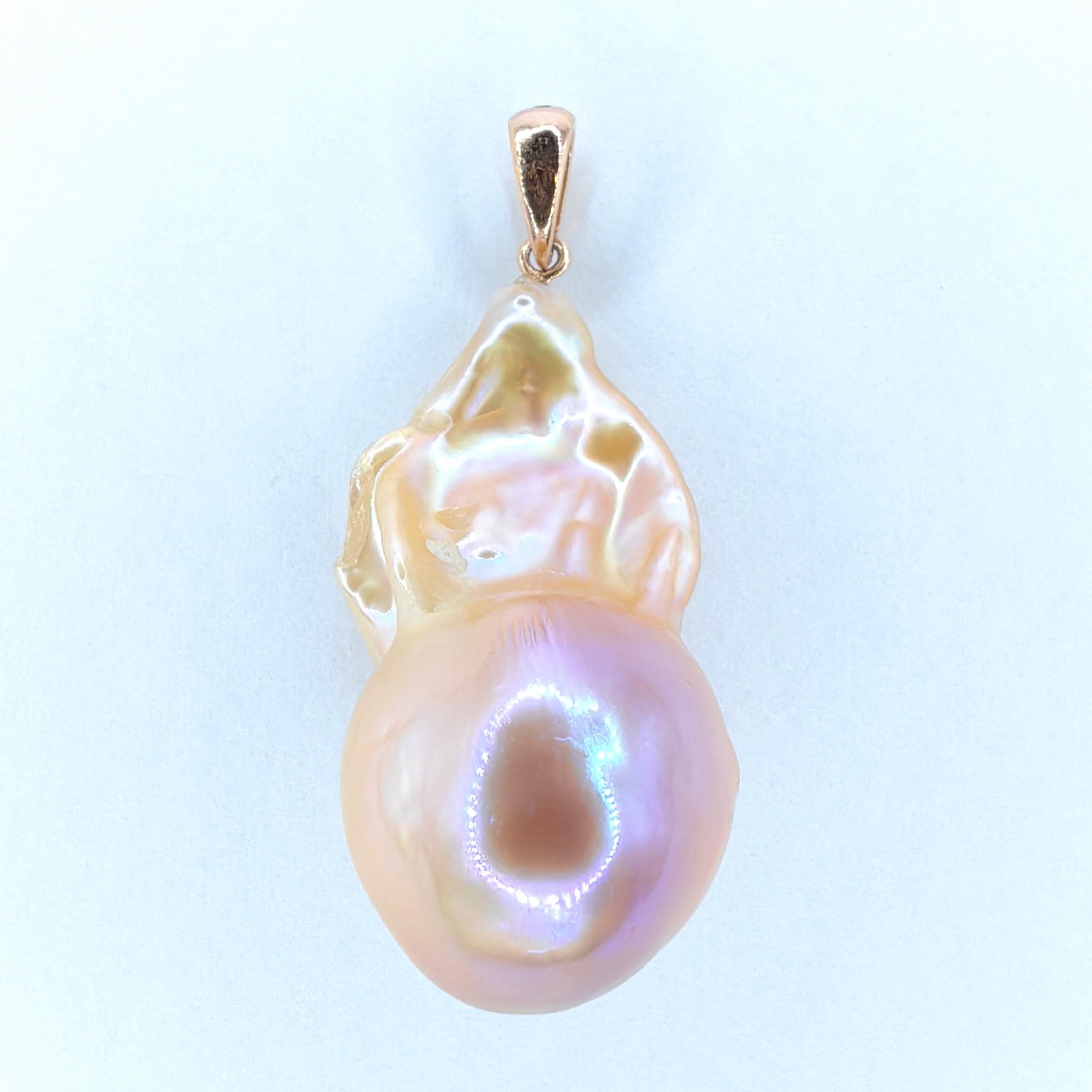 Introducing our enchanting 24.18ct Unicorn Hue Large Baroque Pearl Pendant Necklace in 18K Yellow Gold, a mesmerizing piece that exudes natural beauty and sophisticated elegance.

At the heart of this pendant lies a magnificent 24.18-carat baroque