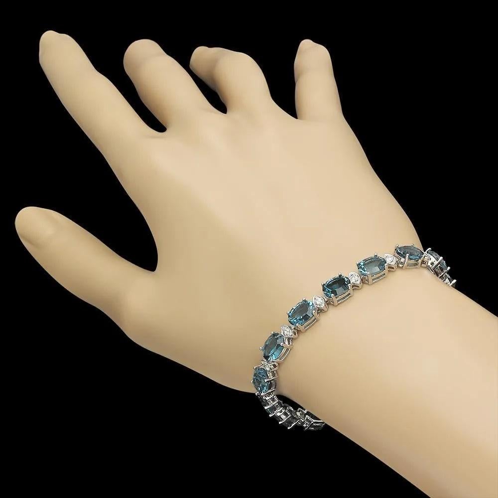 24.20 Natural Blue Topaz and Diamond 14K Solid White Gold Bracelet

Total Natural Blue Topaz Weight is: Approx. 23.30 carats 

Blue Topaz Measure: Approx. 8 x 6 mm

Total Natural Round Diamonds Weight: Approx. 0.90 Carats (color G-H / Clarity