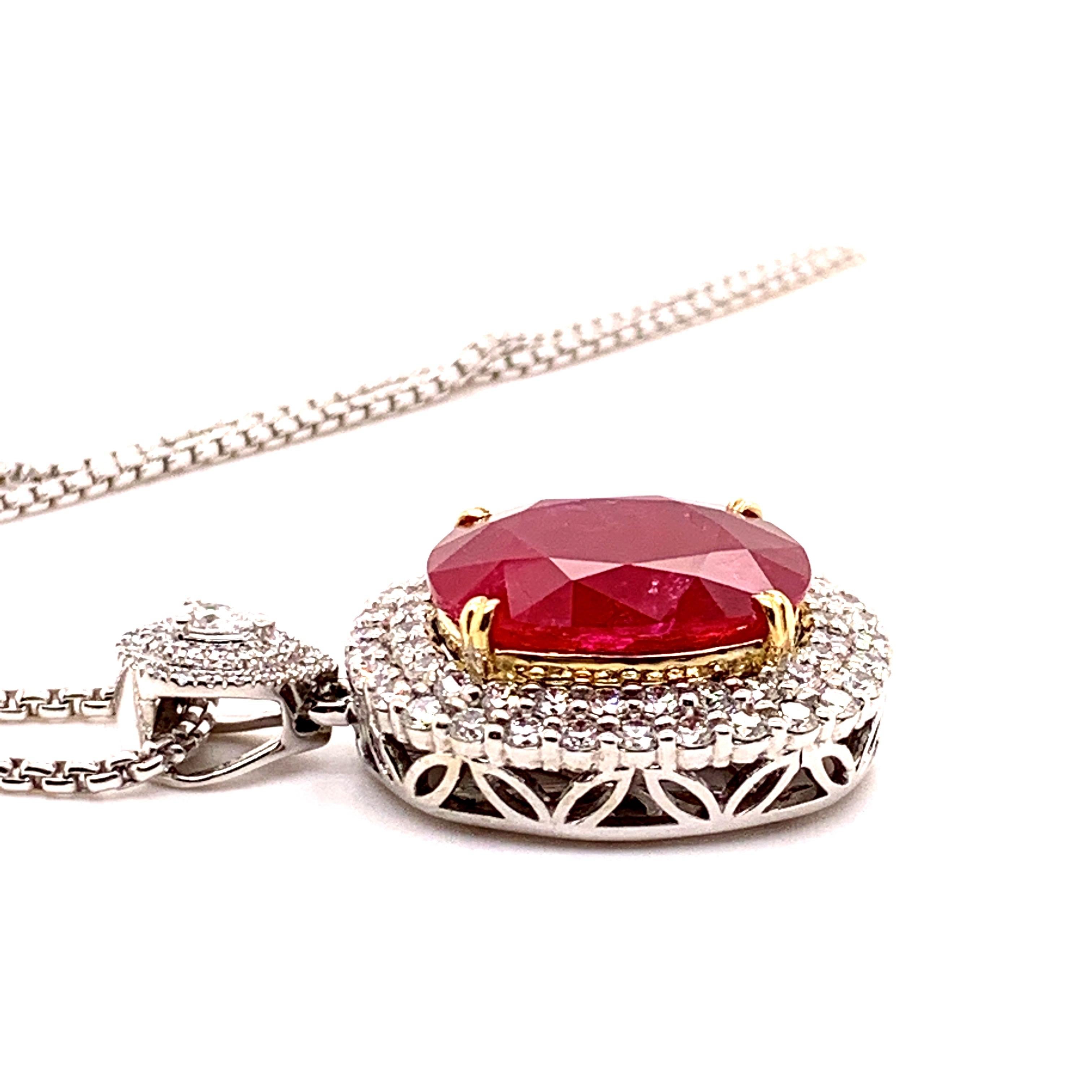 Glamorous large ruby diamond pendant necklace. Intense fiery red, high luster, cushion faceted, 24.21 carats natural ruby mounted in high profile with yellow gold eight knife prongs, accented with two rows of round brilliant cut diamonds, bail with