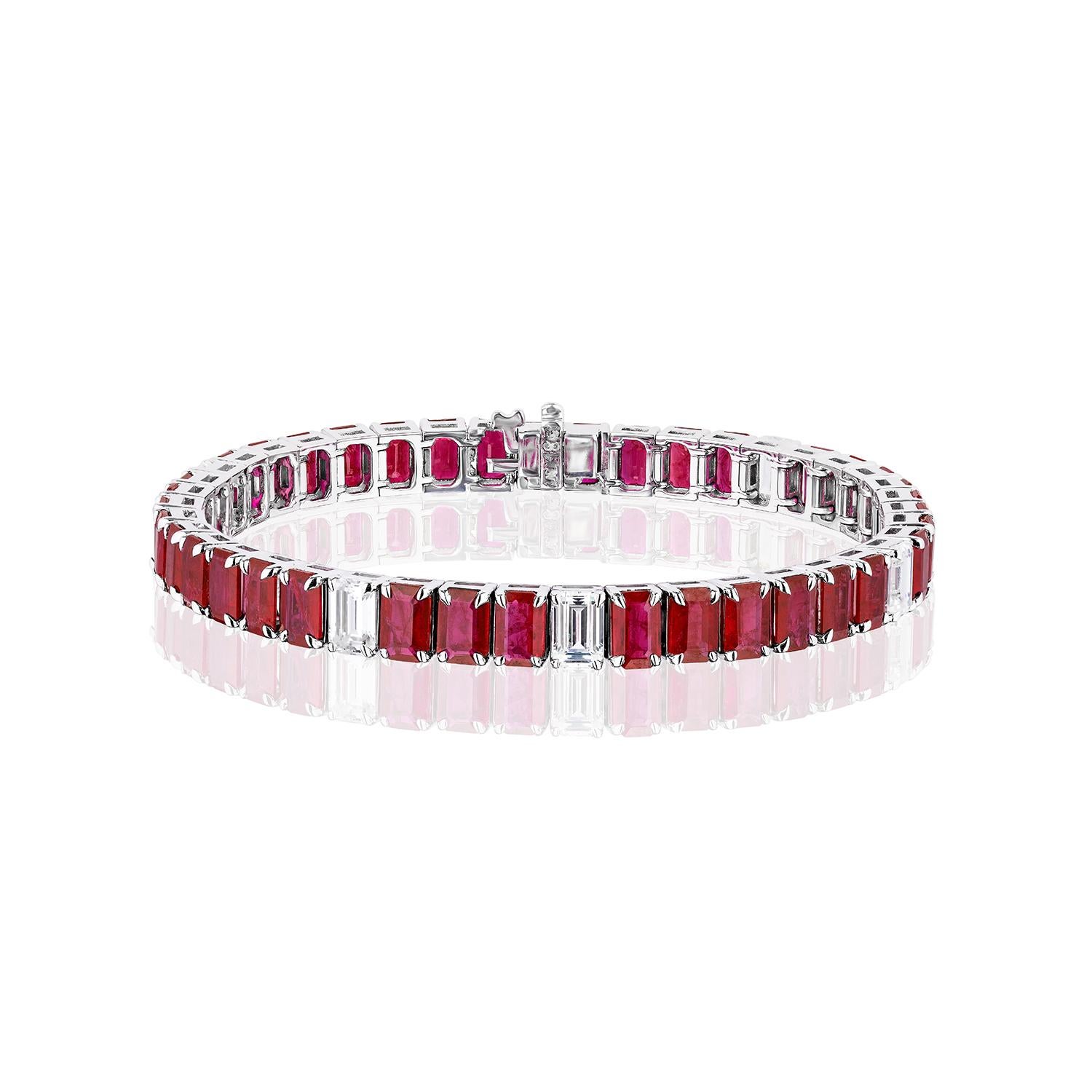 38 beautifully matched Emerald Cut Rubies weighing 21.76 Carats and randomly spaced with 5 Emerald Cut White Diamonds weighing 2.53 Carats.

Set in 18 Karat White Gold.
Measures 7 inches.