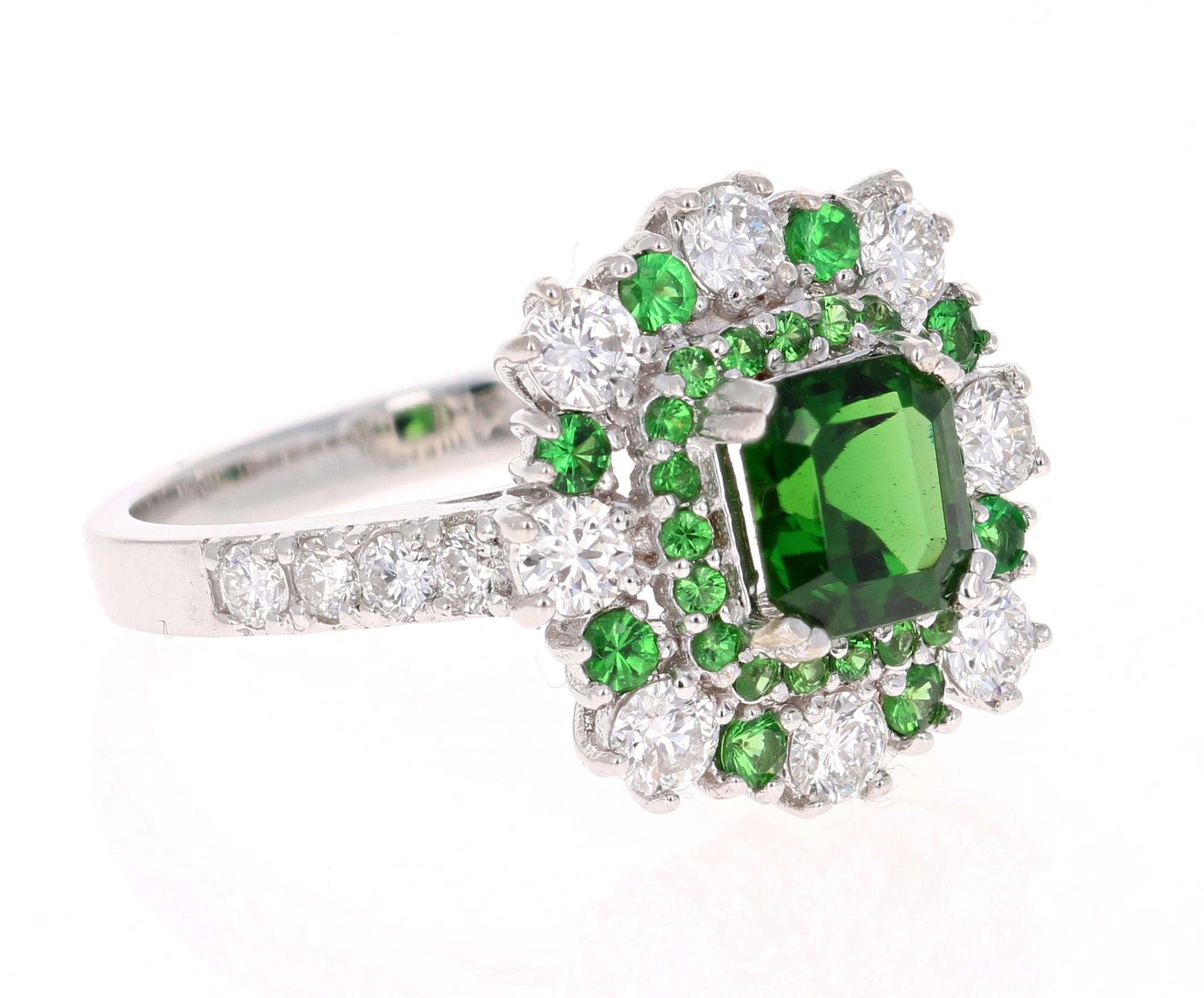 This beautiful ring has a Asscher Cut Tsavorite that is 1.05 Carats. It is embellished with 28 Round Cut Tsavorites that weigh 0.47 Carats and 16 Round Cut Diamonds that weigh 0.91 Carats. The total carat weight of the ring is 2.43 Carats.