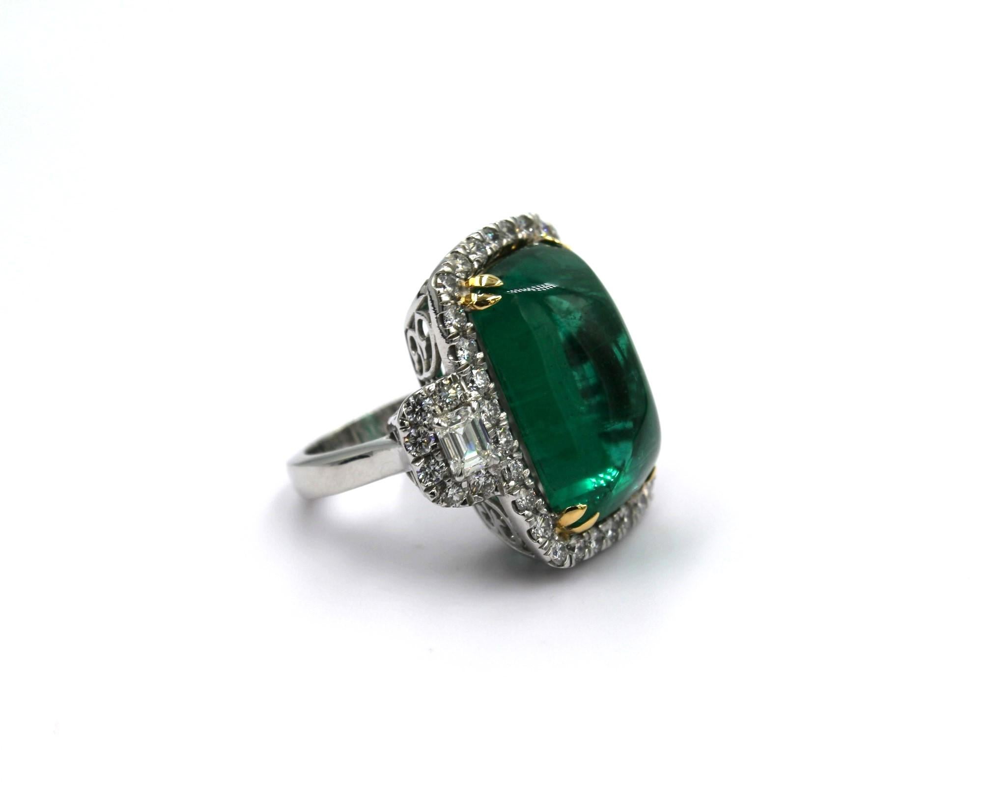 24.32 carats Cabochon Sugarloaf Zambian Emerald with two side emerald cut Diamonds of 0.435 carats on the side and framed with 42 round diamonds totaling a diamond weight of 1.91 carats. 

This piece will highlight your elegance and uniqueness.