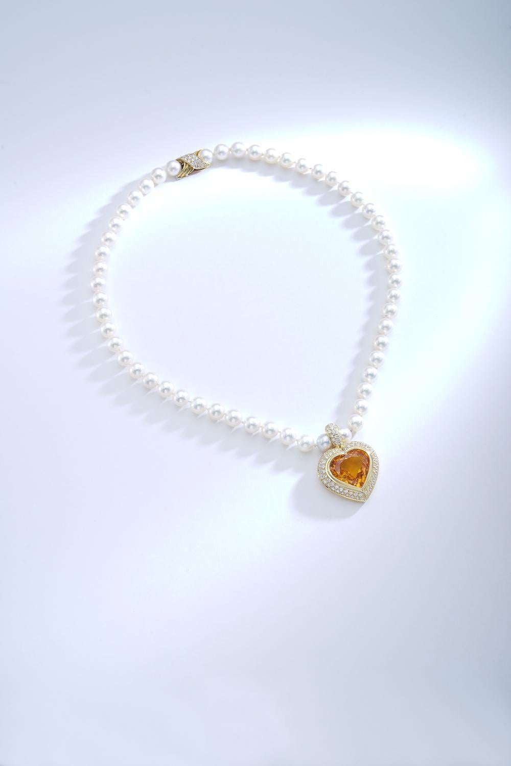 Gorgeous! This yellow Sapphire weights 24.39 carats Heart shape mounted on yellow gold and surrounded by diamond. The pendant is held by cultured pearl necklace and the clasp is in yellow gold with diamond 0.41 carat.
Circa 1980.

By Gubelin