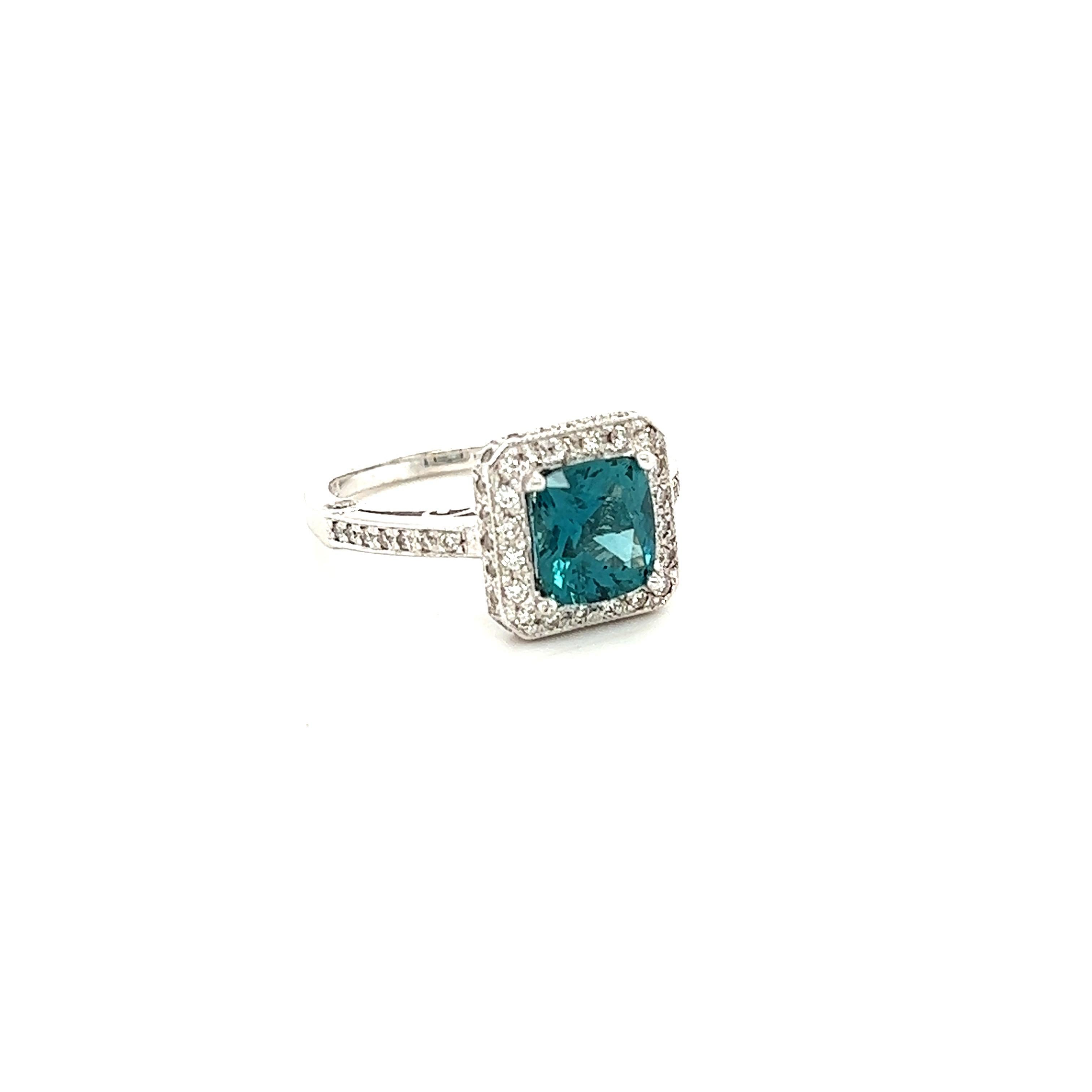 This ring has a 1.93 carat Natural Cushion Cut Apatite in the center of the ring and is surrounded by 62 Natural Round Cut Diamonds that weigh 0.51 carats. The clarity and color of the diamonds are VS-H. The total carat weight of the ring is 2.44
