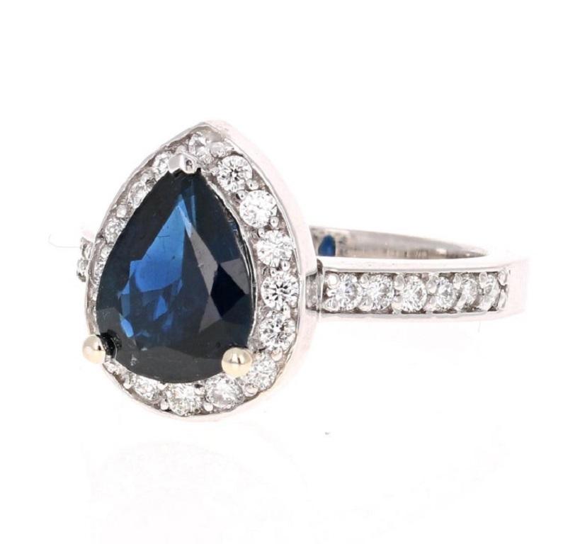 This beautiful setting has a 1.92 carat Pear Cut Sapphire in the center of the ring and is surrounded by 28 Round Cut Diamonds that weigh 0.58 carats.  
The total carat weight of the ring is 2.44 carats. 

The ring is made in 18K White Gold and