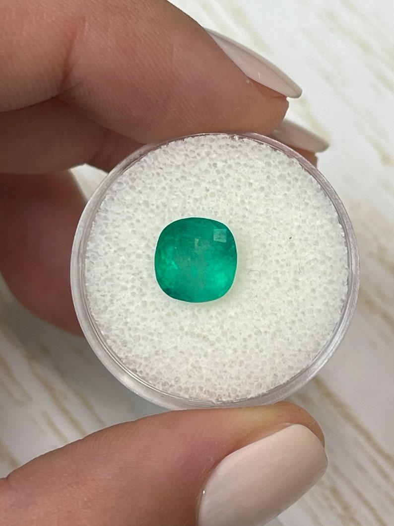 Stone: Emerald
Weight: 2.45-carats
Shape: Cushion Cut
Clarity: Semi-Transparent
Luster: Good
Color: Medium Green
Measurements: 8.60mm x 8.38mm x 5.84mm
Geographic Origin: Colombia
Treatment: Natural, Oiling

Comments: Due to their growth conditions