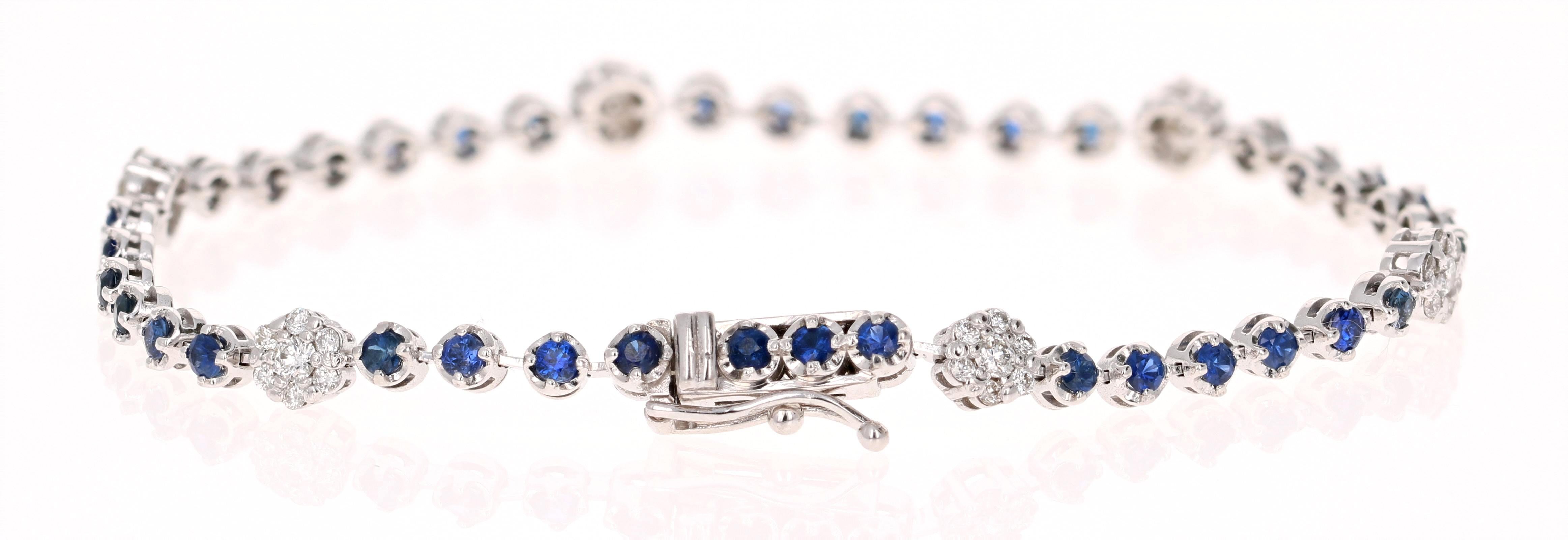 Dainty, Delicate, and Beautiful. 
A 14K White Gold Blue Sapphire and Diamond Bracelet with a flower design. 

The 37 Round Cut Blue Sapphires are 1.84 carats and the 42 Round Cut Diamonds are 0.61 carats, with a total carat weight of 2.45 carats.