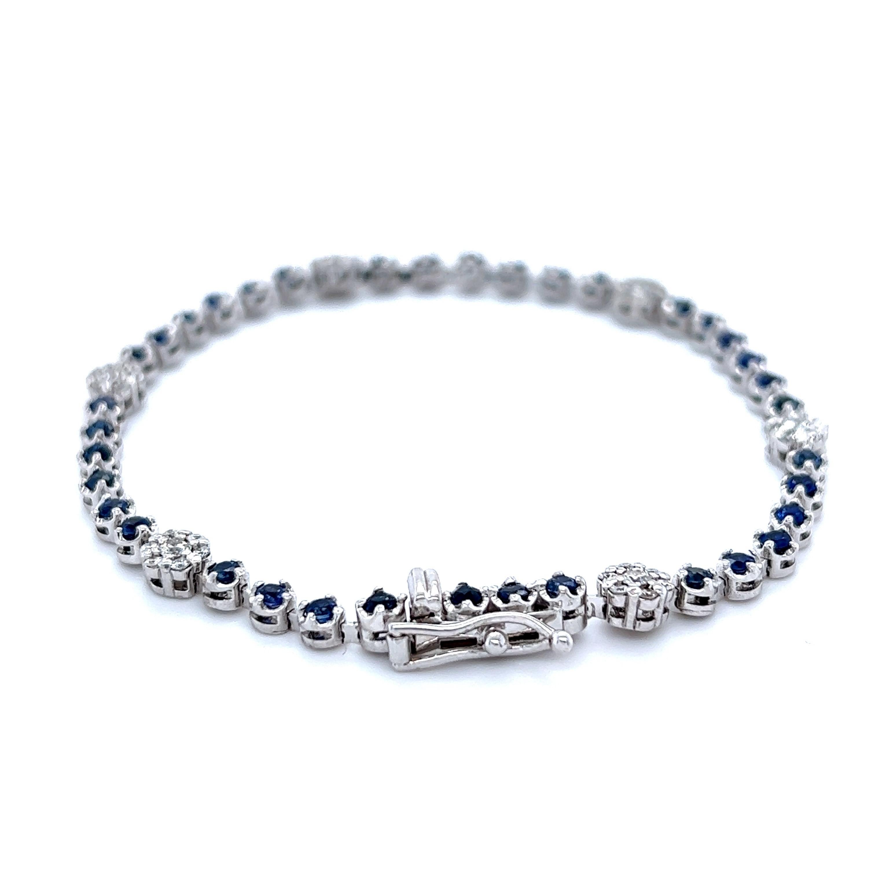 This bracelet has 37 Round Cut Blue Sapphires that weigh 1.84 carats and 42 Round Cut White Diamonds that weigh 0.61 carats. The total carat weight of the bracelet is 2.45 carats. 

It is set in 14 Karat White Gold and has an approximate gold gram