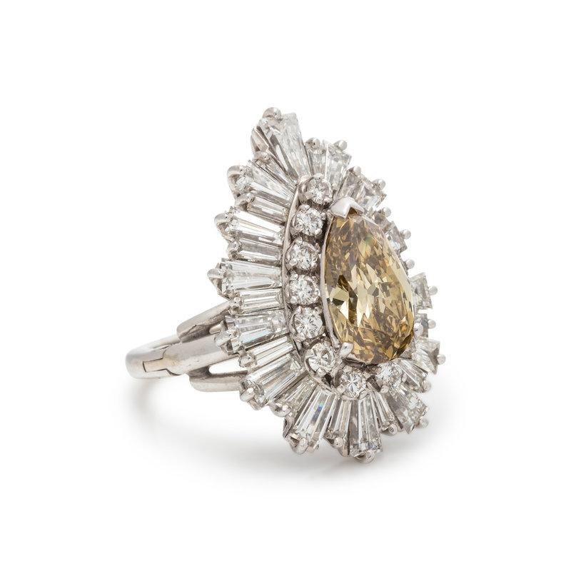 This ballerina inspired cocktail ring features one pear shaped brown diamond, weighing approximately 2.45 carats, surrounded by 28 tapered baguette cut diamonds, weighing approximately 3.80 carats, and 12 round brilliant cut diamonds, weighing