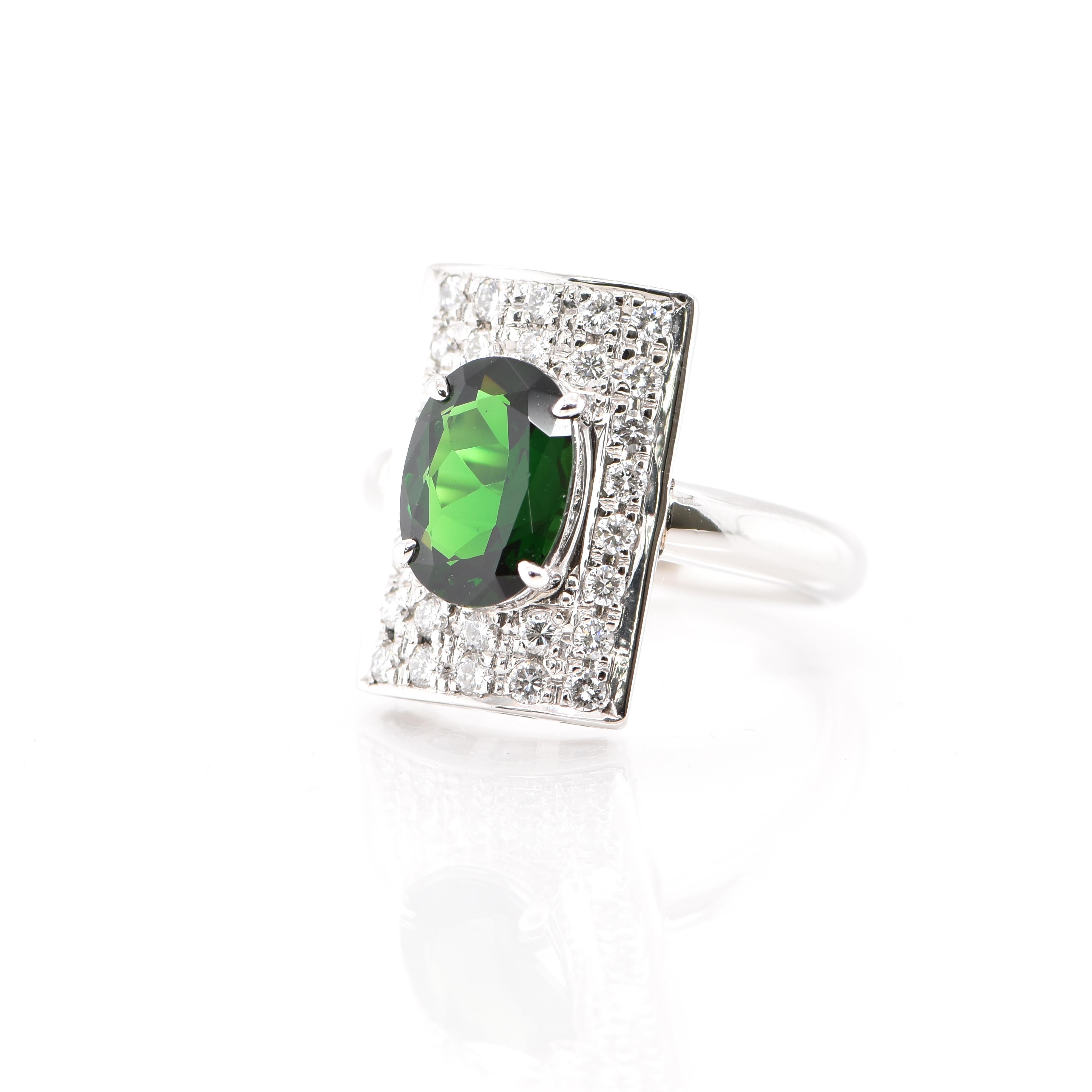 An absolutely gorgeous Art Deco Style Cocktail Ring featuring a 2.45 Carat Tsavorite Garnet and 0.55 Carats of Diamond Accents set in Platinum. Garnets have been adorned by humans throughout history from Ancient Egypt, Rome and Greece. They come in