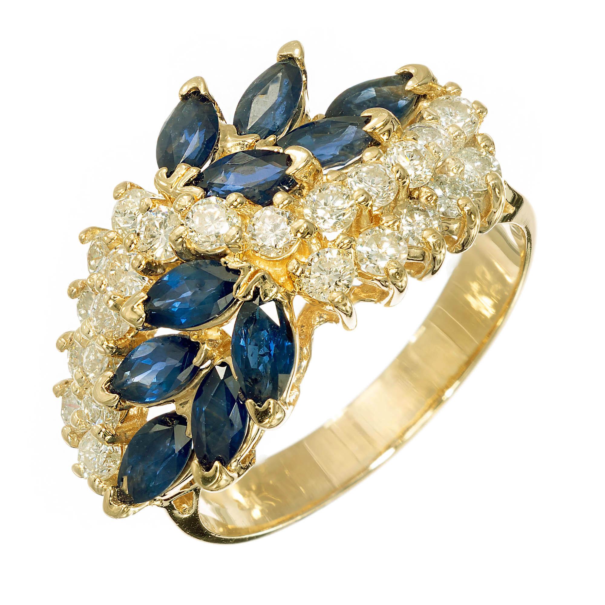Sapphire and diamond wave ring. round brilliant cut diamonds set in 14k yellow gold accented by ten marquise shaped blue sapphires above and below side diamonds.

10 marquise blue sapphires Approximate 1.30 carats
23 round H-I SI diamonds