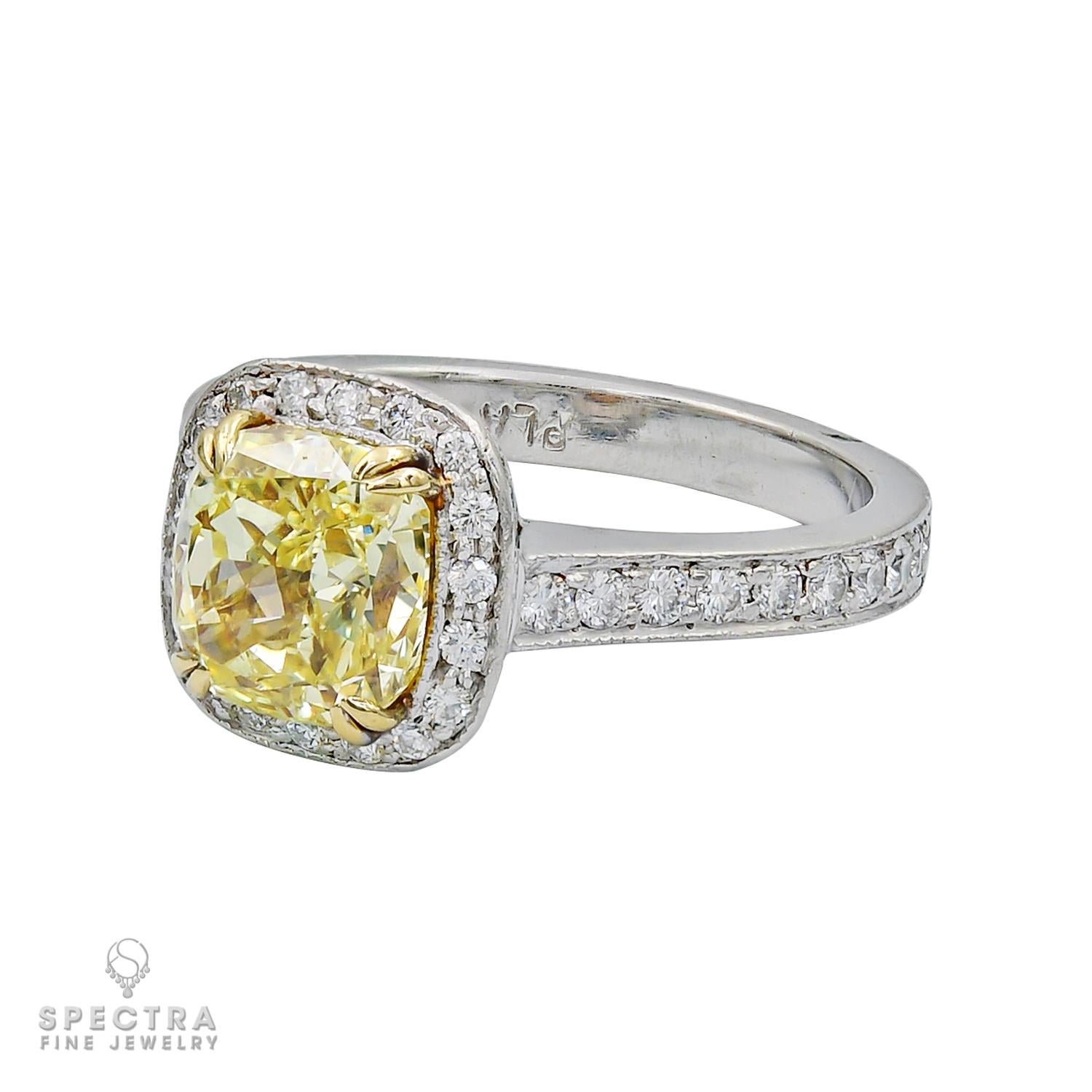 A beautiful engagement/cocktail ring set with a radiant-cut diamond, weighing a total of 2.45 carats. 
The diamond is certified by GIA lab, stating that it is a natural diamond of fancy intense yellow color and even distribution.
The center stone is