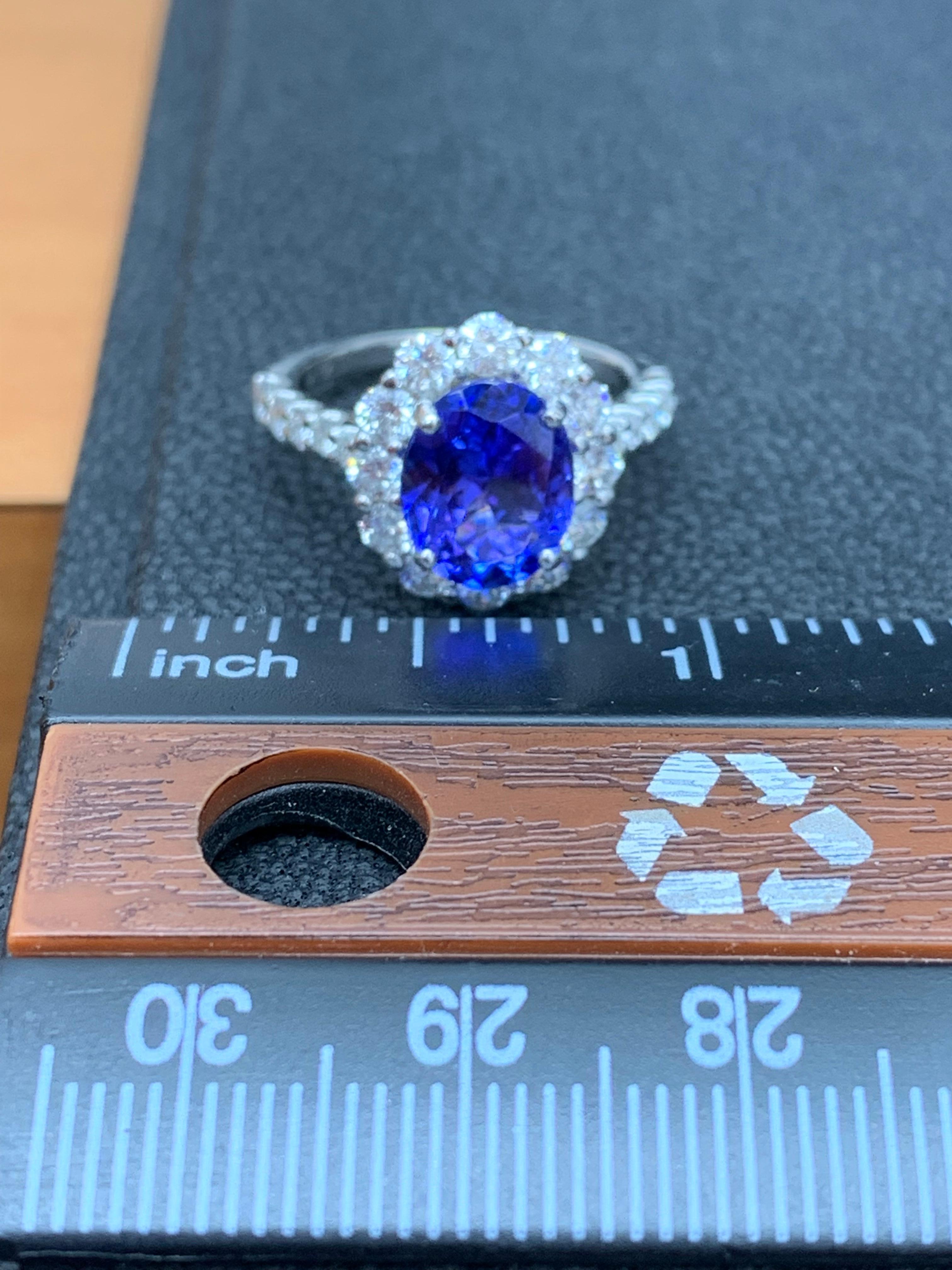 2.45 Carat Oval Cut Tanzanite and Diamond Halo Flower Ring in 18K White Gold For Sale 3