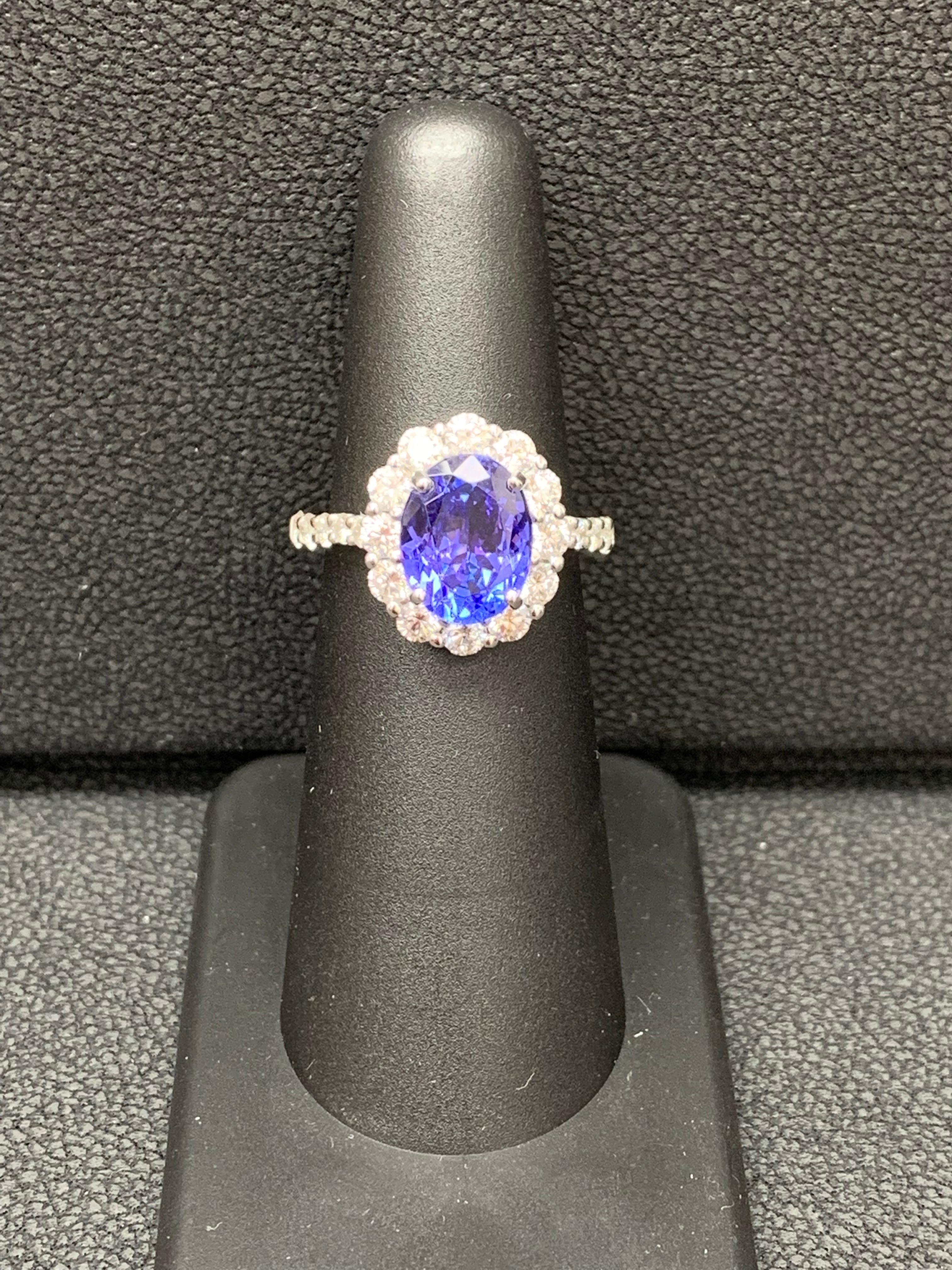 A simple floral motif ring showcasing a vibrant 2.45-carat oval cut tanzanite, surrounded by 
1.20 carats of 22 accent round diamonds. Made in 18 karats white gold.

Style available in different price ranges. Prices are based on your selection of