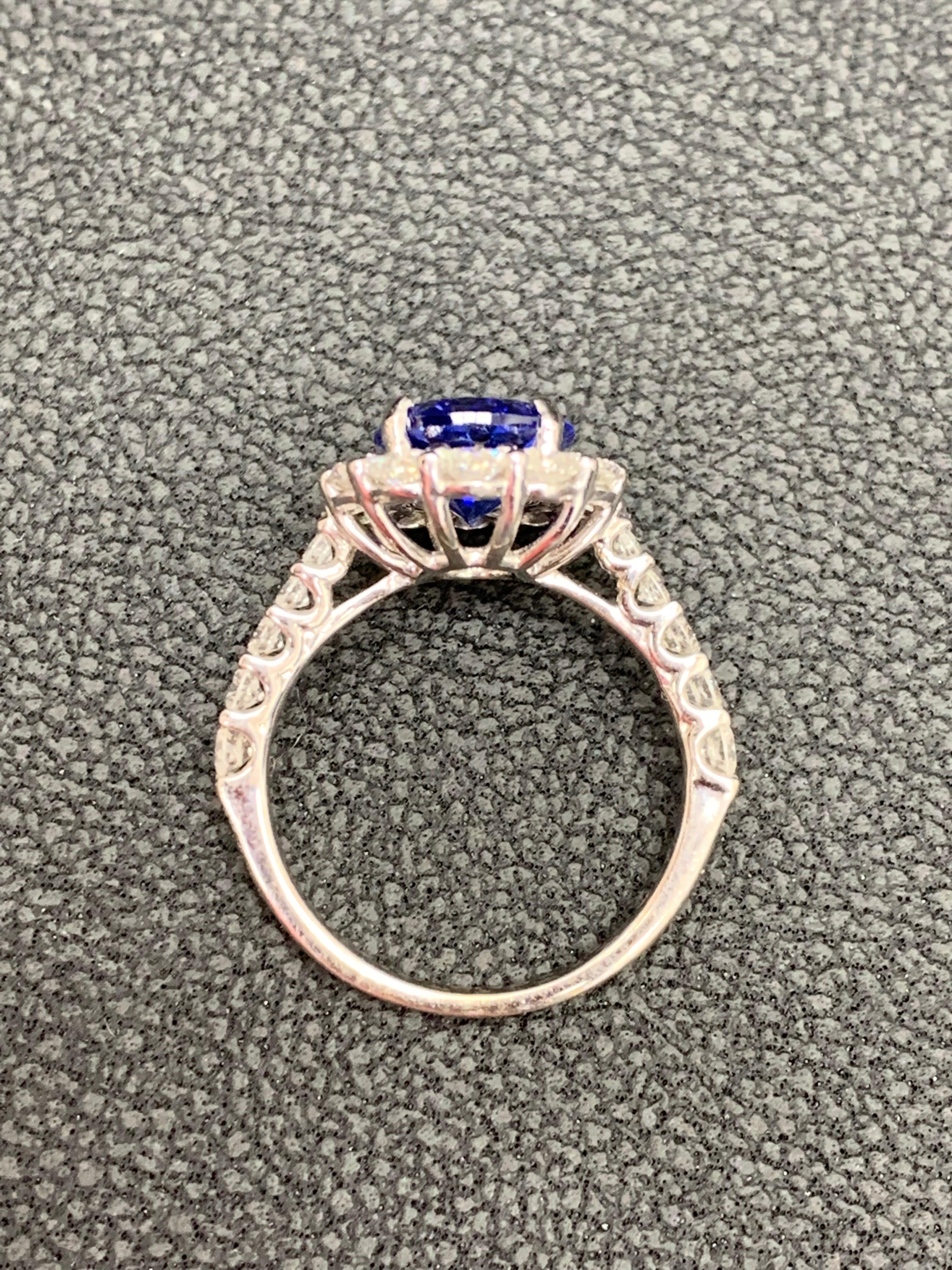 2.45 Carat Oval Cut Tanzanite and Diamond Halo Flower Ring in 18K White Gold In New Condition For Sale In NEW YORK, NY
