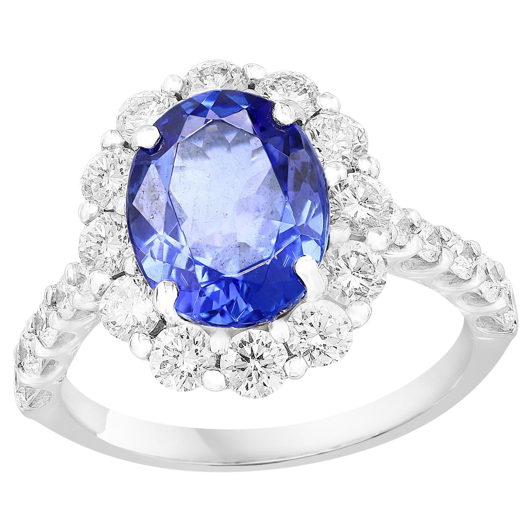 2.45 Carat Oval Cut Tanzanite and Diamond Halo Flower Ring in 18K White Gold For Sale