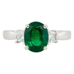 2.45 Carat Oval Emerald Ring with Trapezoid Diamonds 18 Karat in Stock