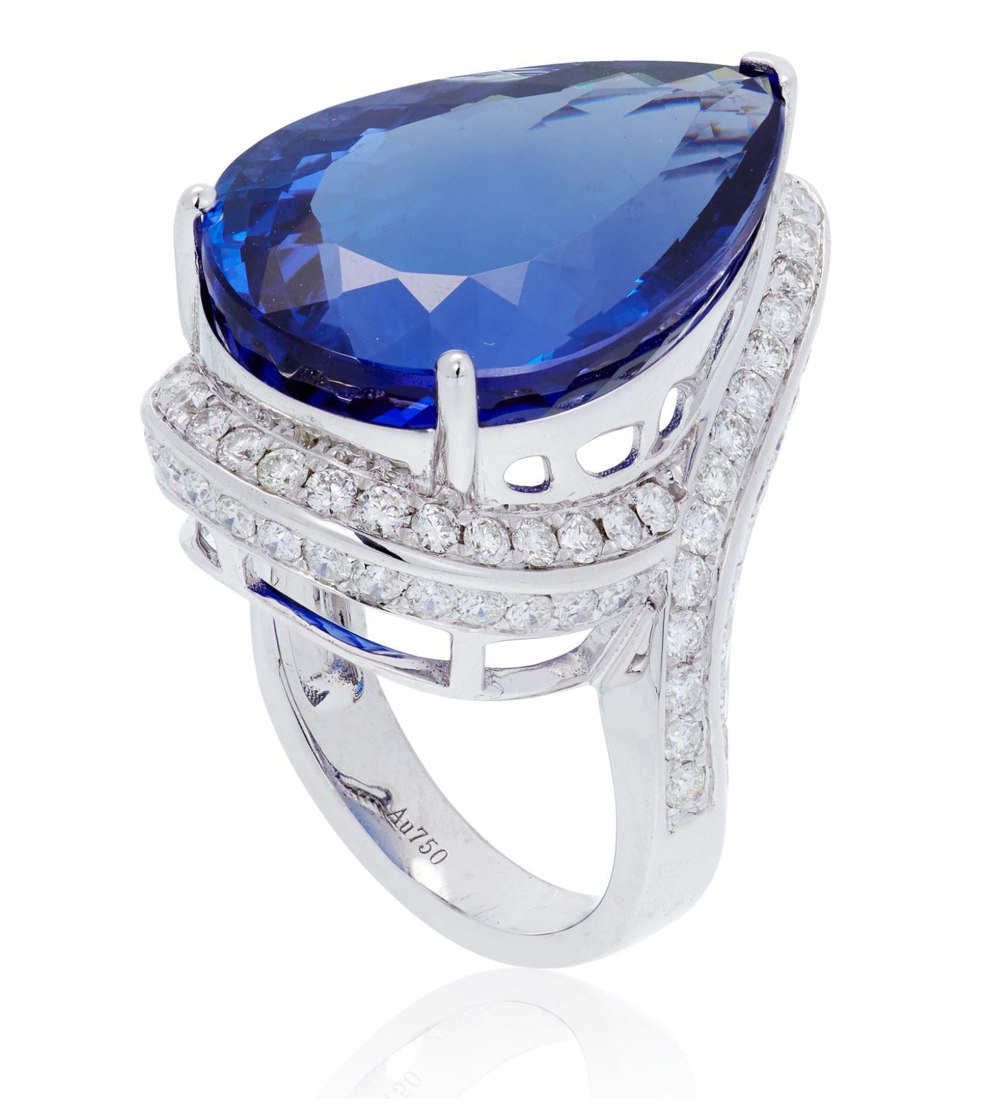 This ring features one pear-shaped tanzanite, weighing approximately 24-25.00 carats, encircled by 86 round diamonds, weighing approximately 1.78 carats, set meticulously in 18K white gold.

MARKS: Au750, d1.78ct
