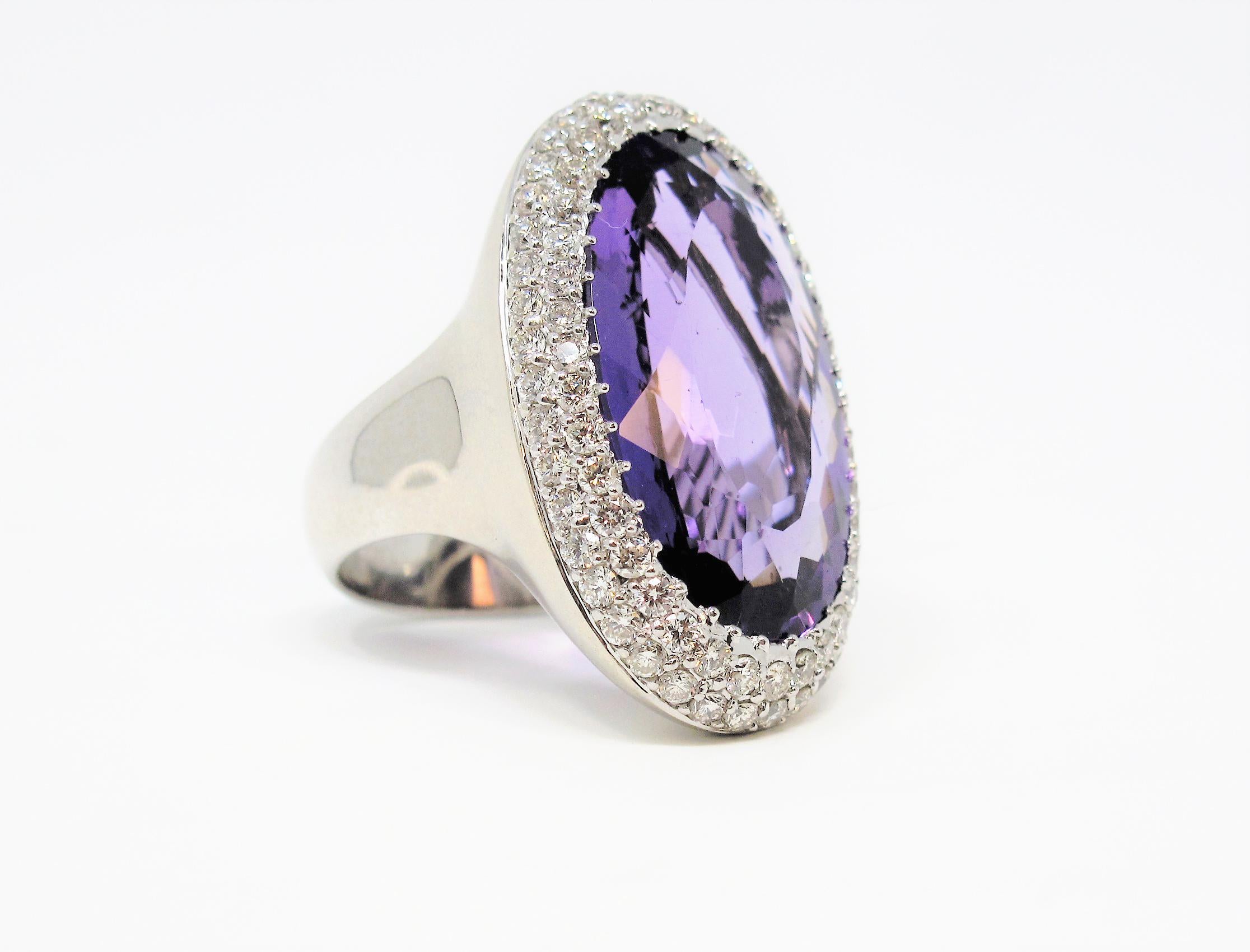 This incredible amethyst and double diamond halo cocktail ring will absolutely light up your finger. The stunning oversize amethyst stone sparkles spectacularly with its vibrant, crystal clear purple color. The double halo of icy white diamonds