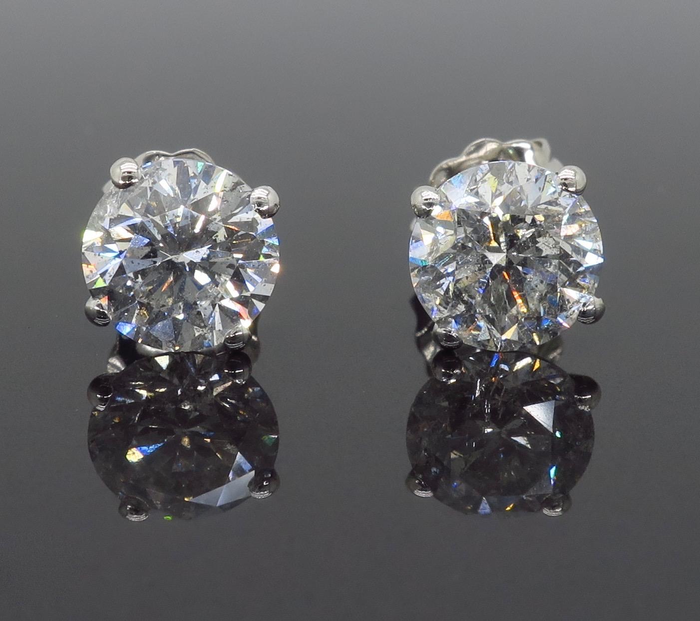 Classic 2.46CTW diamond stud earrings crafted in 14k white gold.

Diamond Carat Weight: Approximately 2.46CTW 
Diamond Cut: Round Brilliant Diamonds
Color: Average G-H
Clarity: Average I2
Metal: 14K White Gold 
Marked/Tested: Stamped “14K