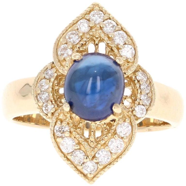 This ring has a Natural Oval Cut Cabochon Cut Sapphire that weighs 2.13 carats and measures at 7.5 mm x 6.5 mm. 

It also has 22 Round Cut Diamonds that weigh 0.33 carats. The total carat weight of the ring is 2.46 carats. The Clarity and Color is