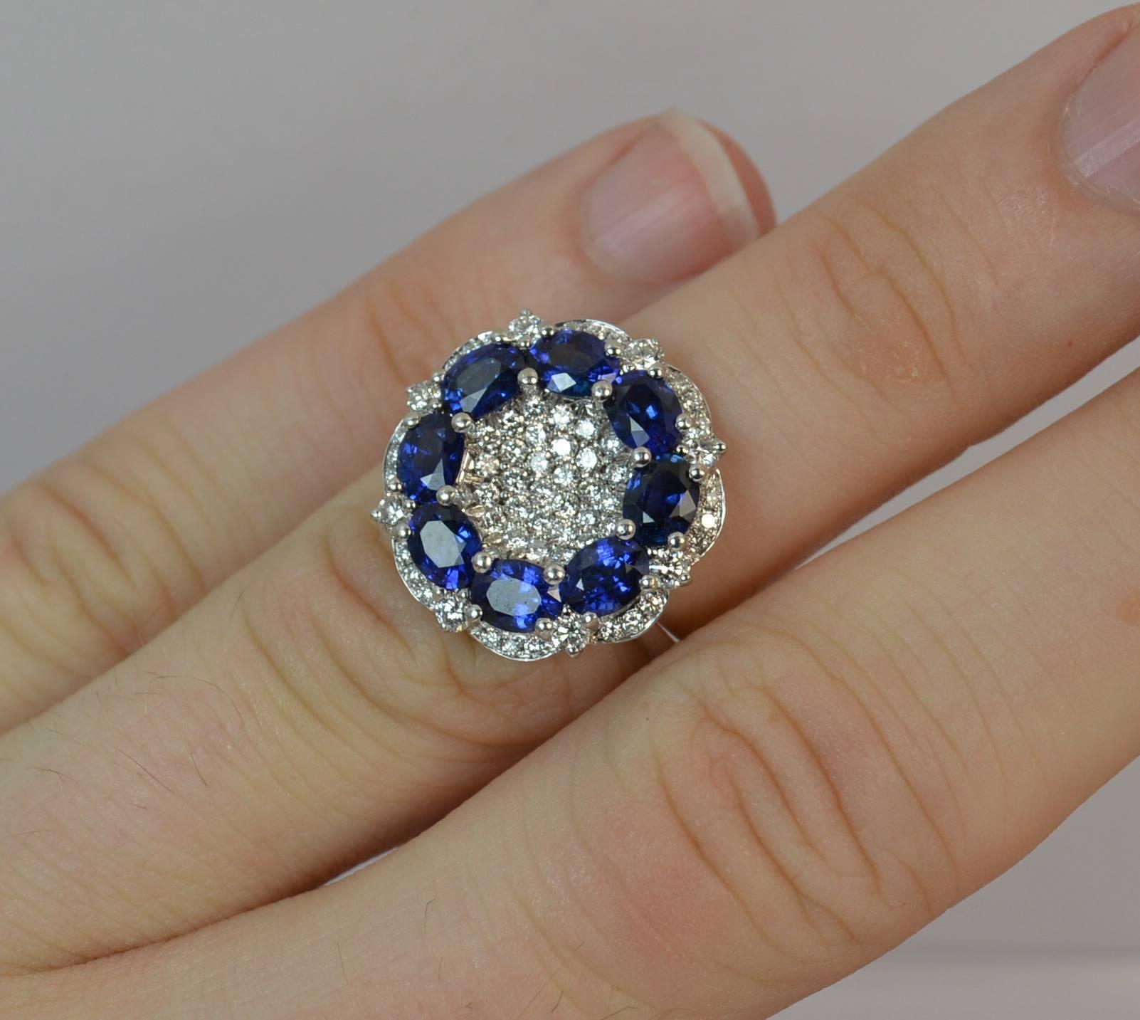 
A stunning Sapphire and Diamond cluster ring.

Modelled in solid 18 carat white gold.

​Designed with a disc of oval cut vivid blue sapphires to total 2.46 carats as confirmed to the band. To the centre are multiple round brilliant cut diamonds