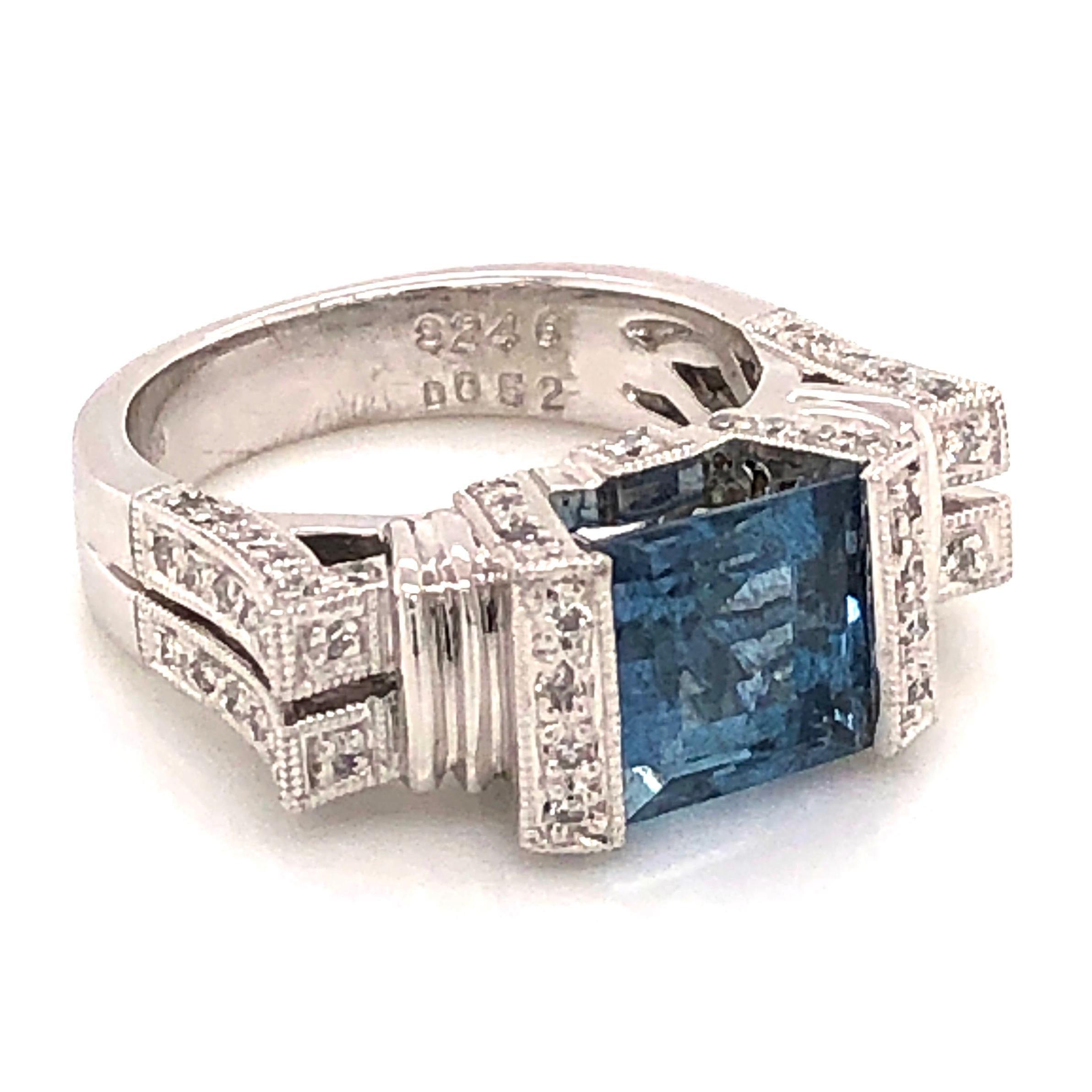 Simply Beautiful! Finely crafted Square and Diamond Ring. Centering an amazing Hand set securely nestled Square Deep Aquamarine weighing approx. 2.46 Carat with Diamonds on either side and on shank, weighing approx. 0.52tcw. Ring size: 6.25, we