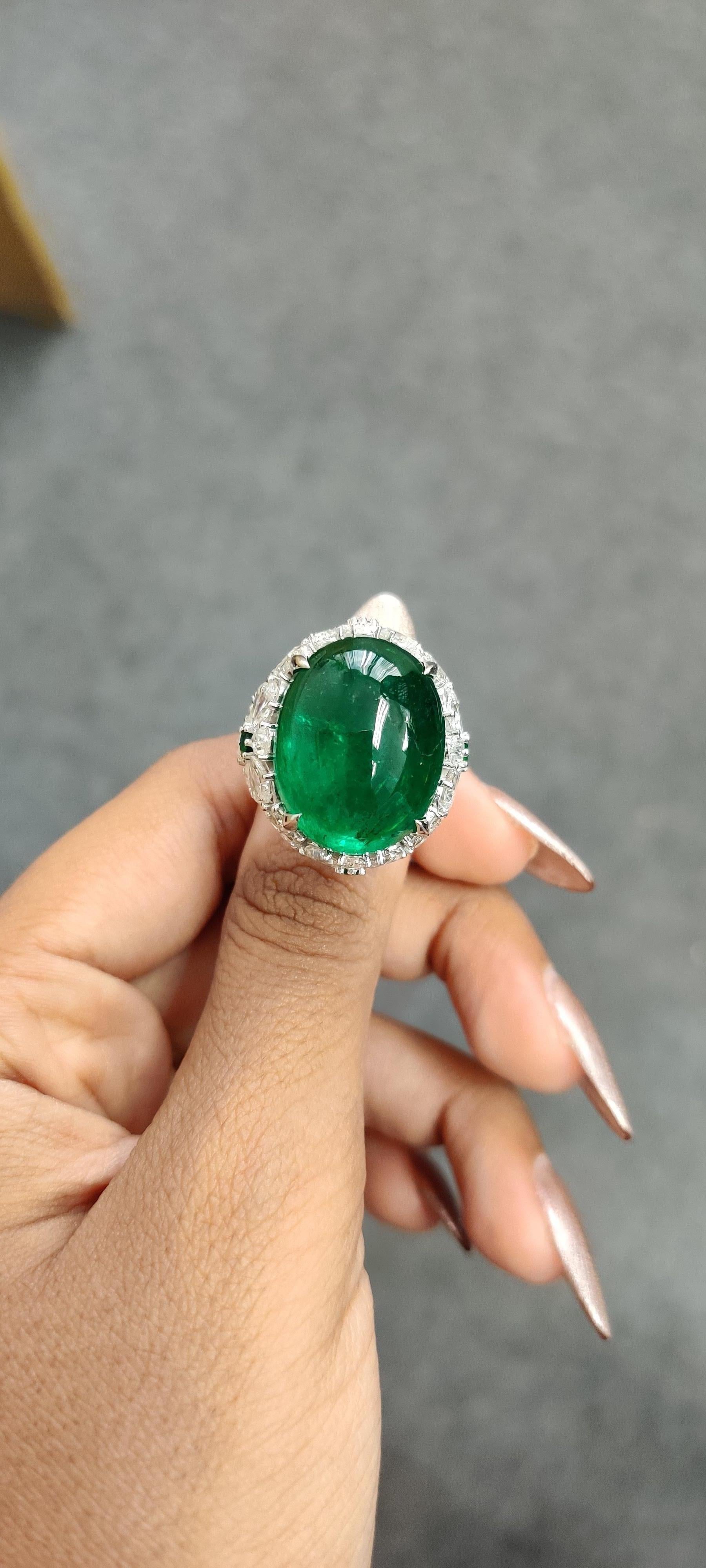 Presenting this utterly breath-taking and substantial piece of jewelry, we proudly showcase a tremendous 24.60 Carat Cabochon Emerald. Sourced from the enchanting mines of Zambia, this exceptional gem has undergone only minor oil treatment,