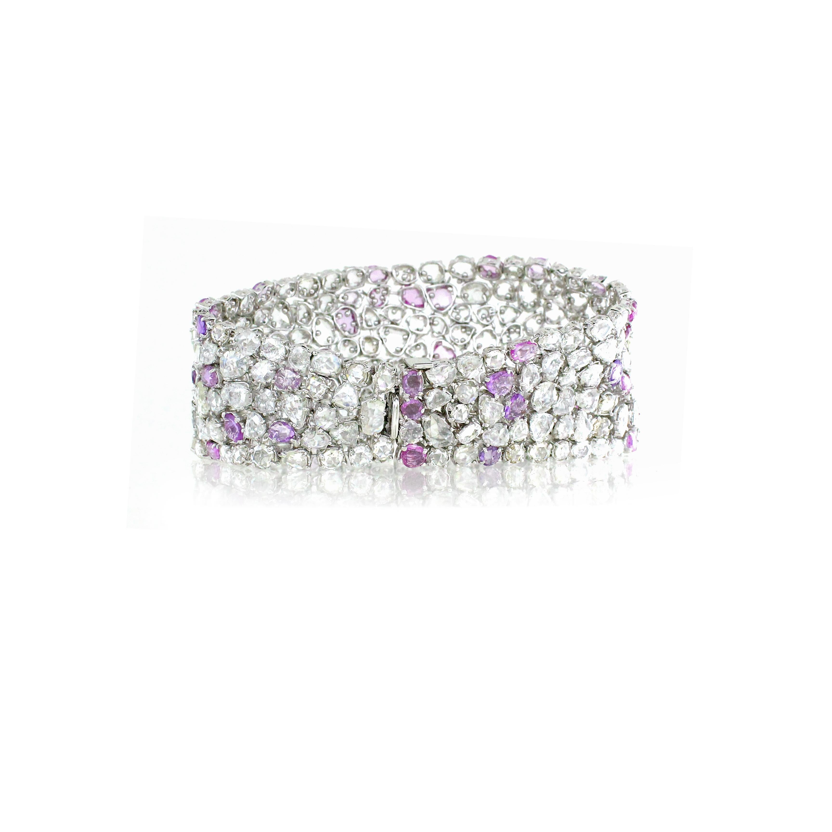 This exquisite link bracelet is a stunning blend of luxury and elegance, featuring 24.68 carats of rose-cut white diamonds and 11.05 carats of vibrant pink sapphires. Each gemstone is meticulously set in 18k white gold, weighing 66.98 grams,