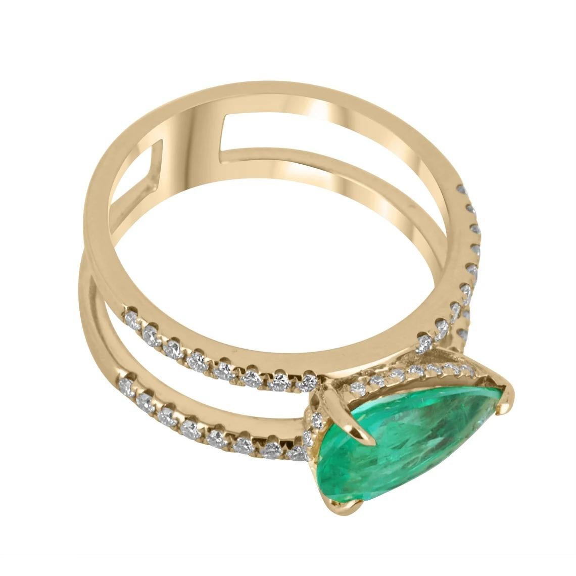 An absolutely stunning, Colombian emerald and diamond ring. The center stone features a lovely 2.03-carat, pear-cut Colombian emerald as it lays east to west, set in a 3-prong setting. The diamond shank is split, parallel to one another with pave