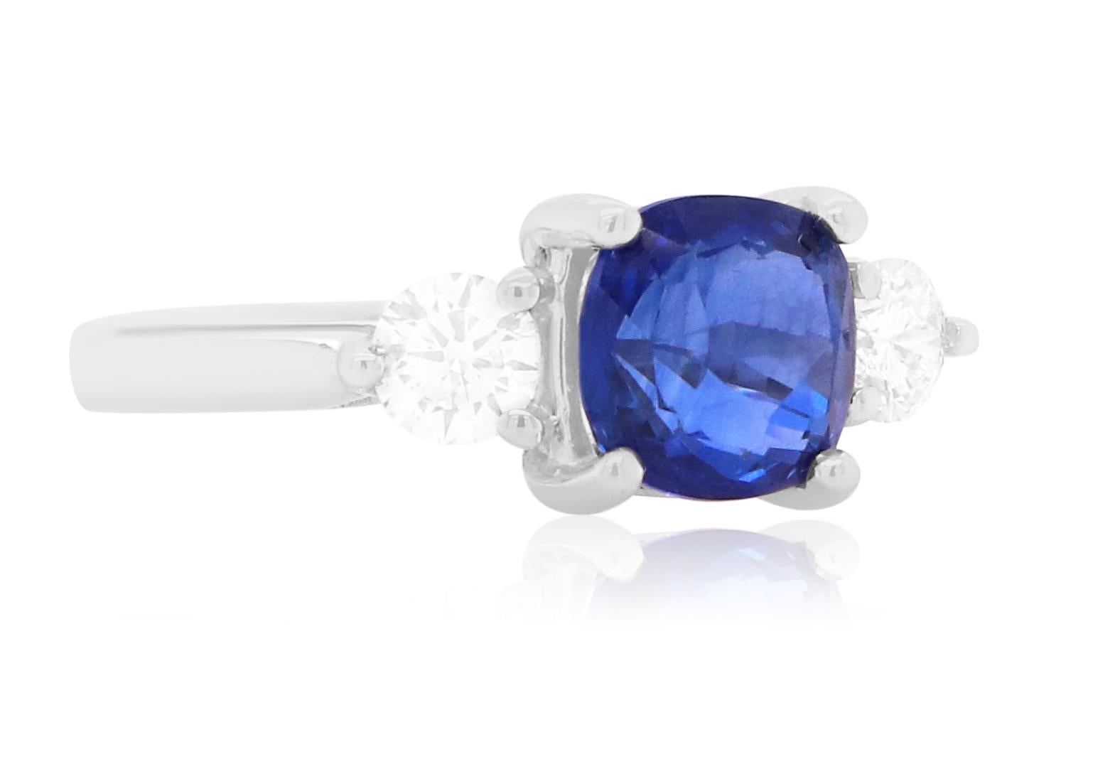 Material: 18k White Gold 
Center Stone Details:  1 Cushion Cut Blue Sapphire at 2.47 Carats 
Diamond Details: 2 Brilliant Round White Diamonds at Approximately 0.5 Carats - Clarity: SI / Color: H-I
Alberto offers complimentary sizing on all