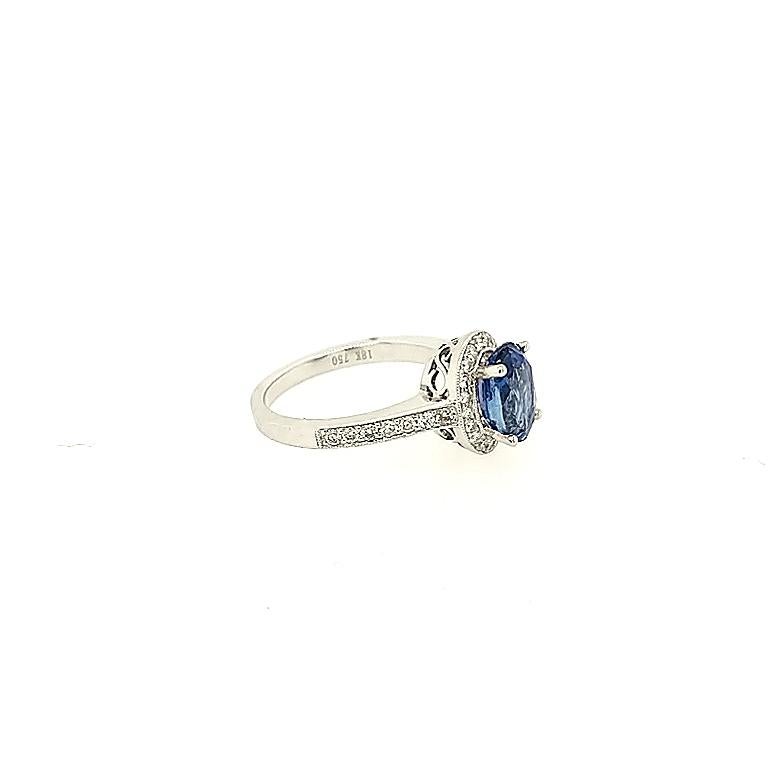Crafted in 18k white gold featuring (1) oval blue sapphire weighing 2.47ct and surrounded by (34) round diamonds weighing .49cttw with a color of G/H and a clarity of SI1 to SI2. The ring is a size 6.5
