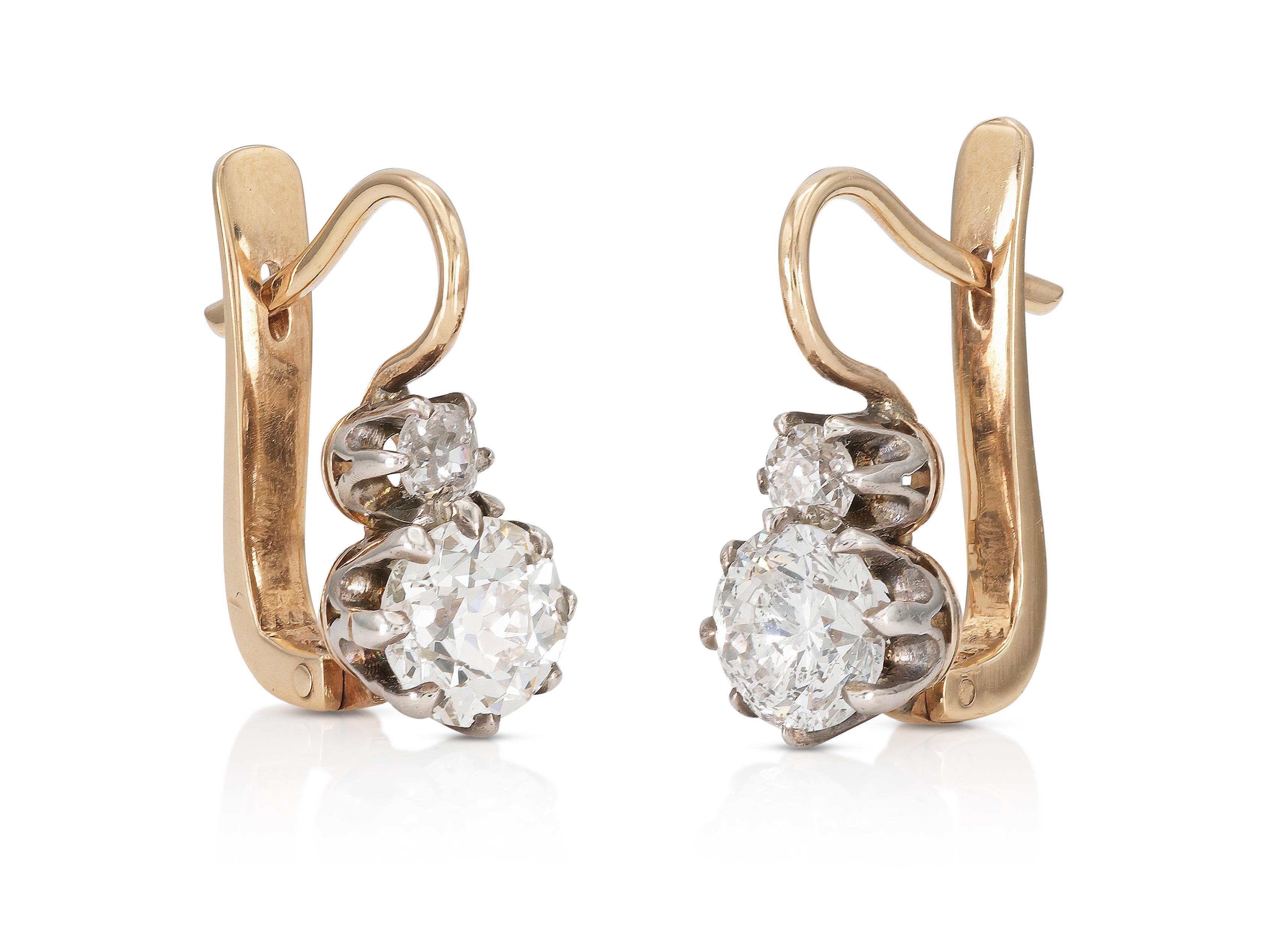 Finely crafted in 14k rose and white gold with one Old European and one Round Brilliant cut bottom Diamond weighing a total of 2.17 carats, and 2 smaller Old European cut top Diamonds weighing a total of 0.30 carats.