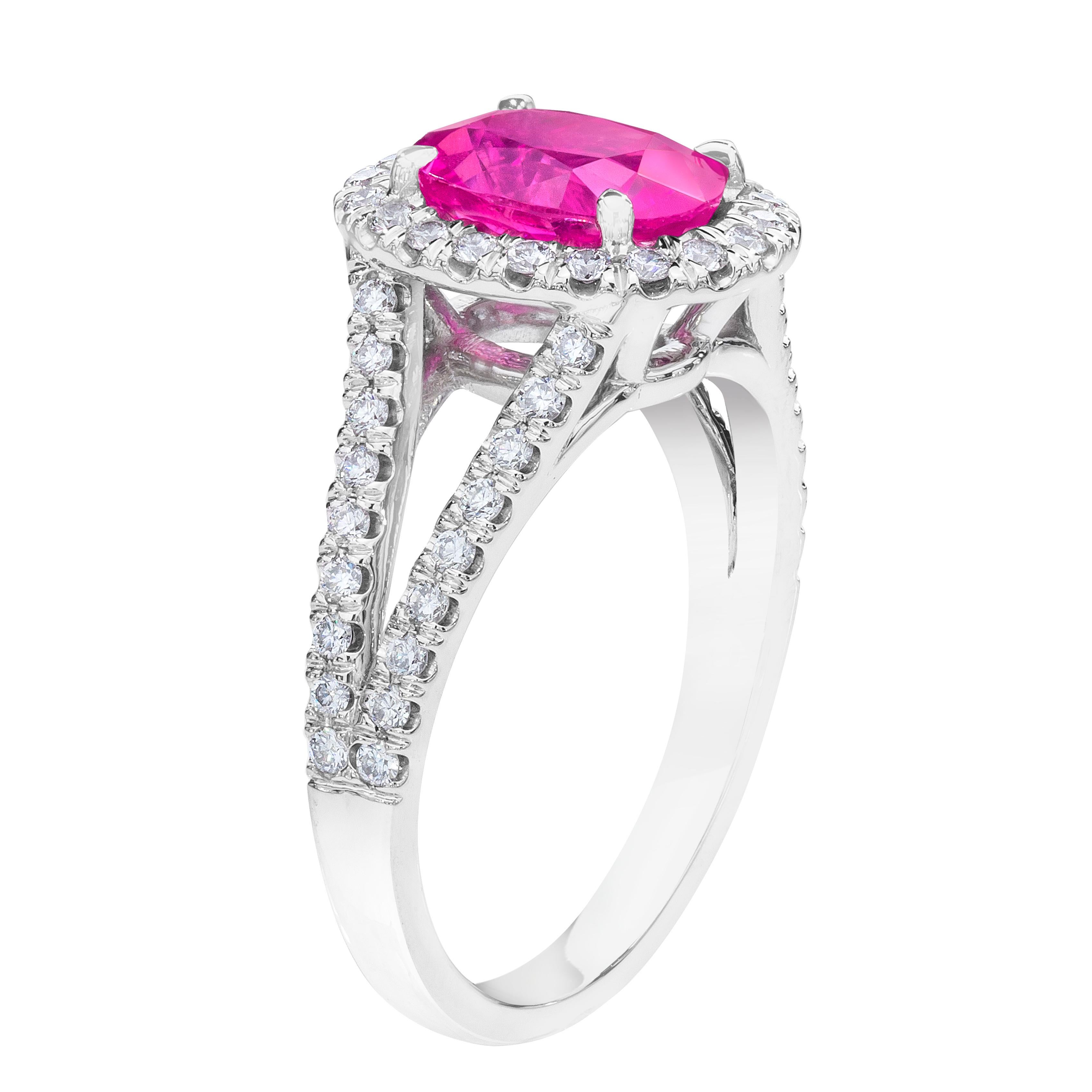 2.47 carat oval pink sapphire and round diamonds set in a platinum split shank ring. This ring is currently a size 7.  We will resize to your finger size without charge.
