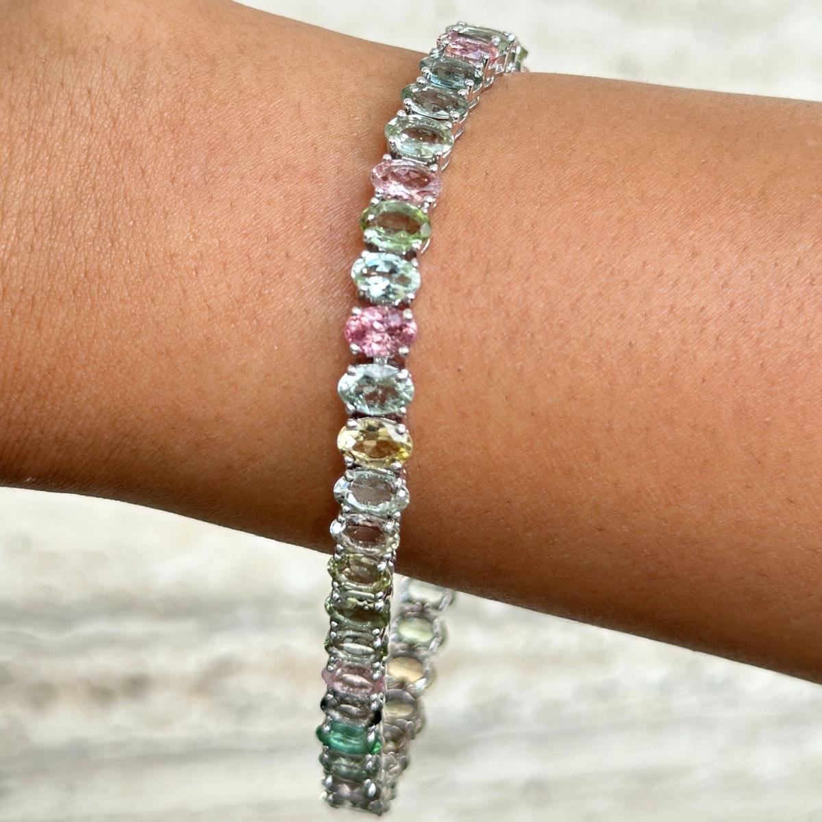 24.75 Carats Multi Tourmaline Tennis Bracelet in sterling silver showcases endlessly sparkling natural multi tourmaline, weighing 24.75 carat. It measures 7 inches long in length. 
Multi Tourmaline stimulate concentration and reduces stress.