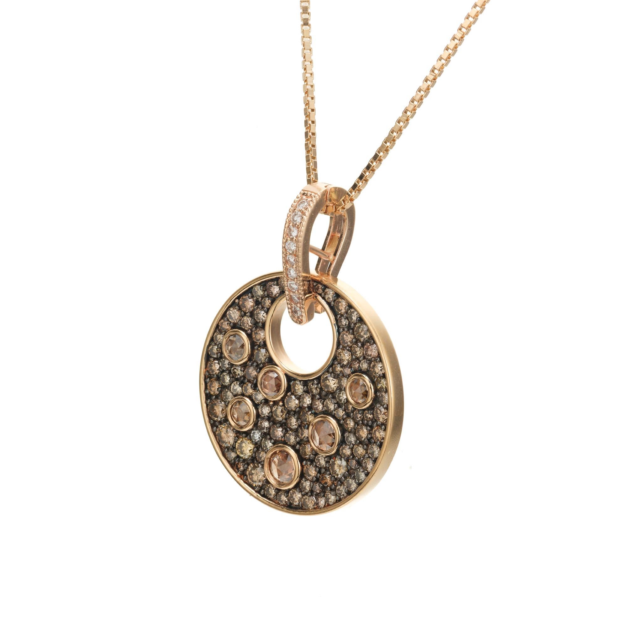 Diamond round pendant necklace. 117 orange/brown chocolate and white diamonds totaling 2.48cts in a round 18k rose and yellow gold pendant. 18 inch 18k yellow gold chain.

6 rose cut orange brown diamonds, SI approx. .68cts
102 round brilliant cut